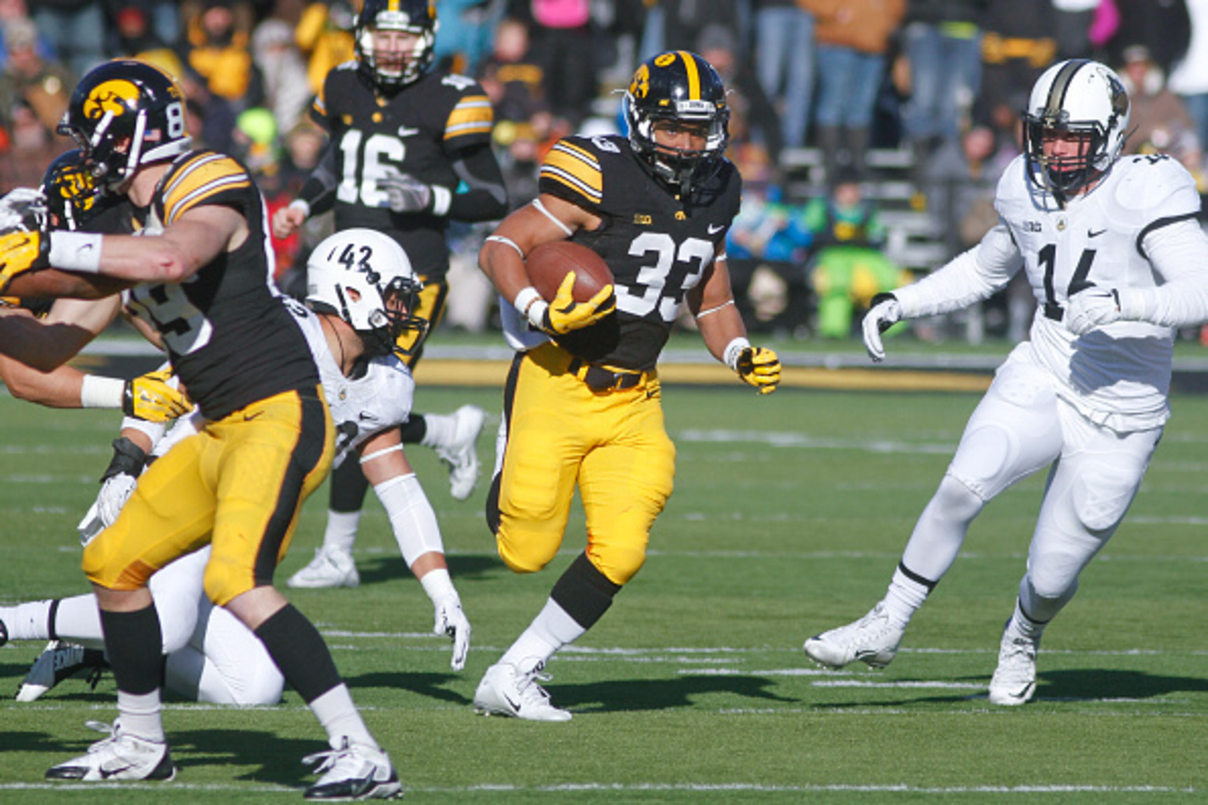 IOWA CITY, IA - NOVEMBER 21: Runningback Jordan Canzeri #33 of the Iowa Hawkeyes runs up the field in the second half in front of linebacker Garrett Hudson #16 of the Purdue Boilermakers on November 21, 2015 at Kinnick Stadium, in Iowa City, Iowa. (Photo 