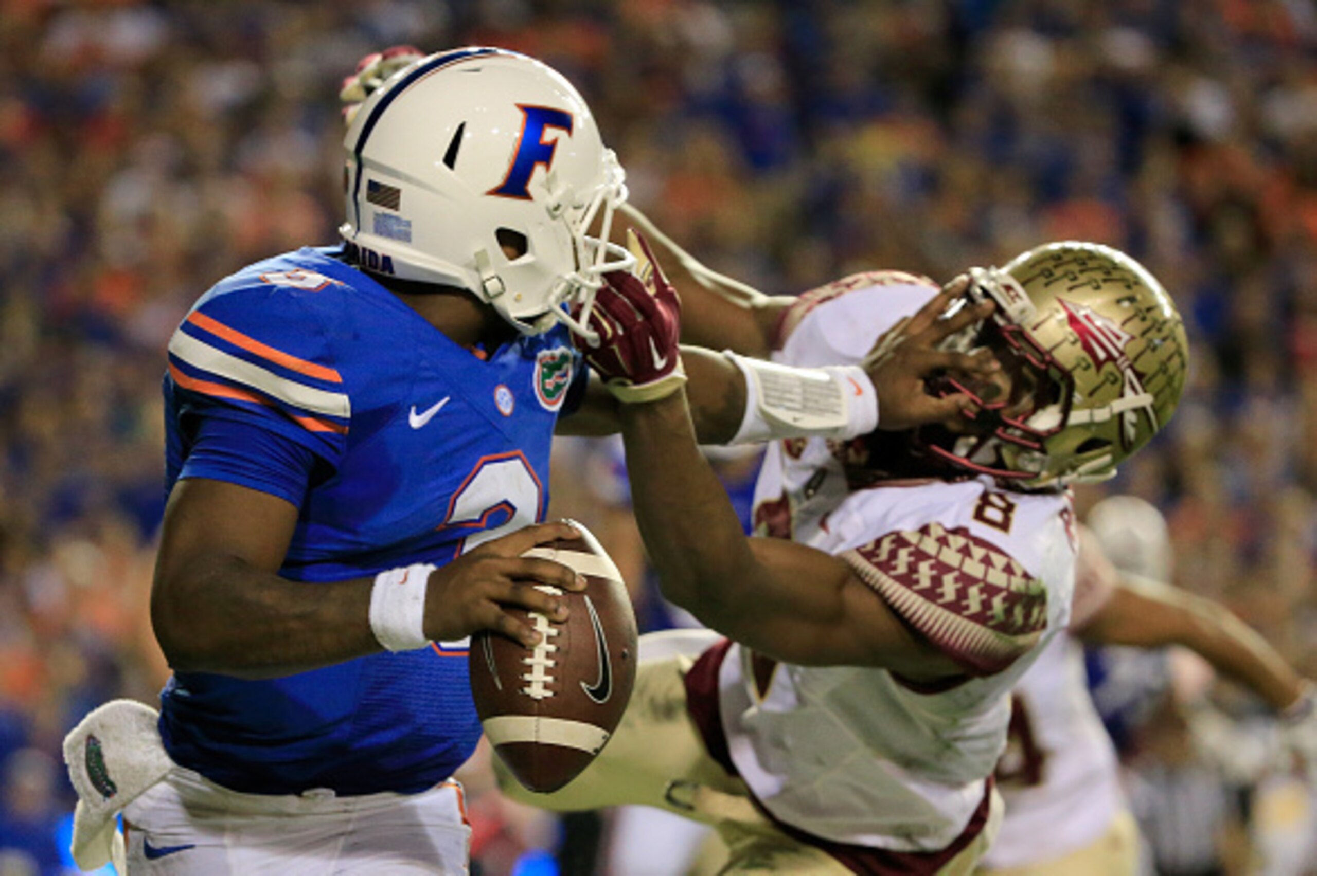 GAINESVILLE, FL - NOVEMBER 28:  Jalen Ramsey #8 of the Florida State Seminoles attempts to tackle Treon Harris #3 of the Florida Gators during the game at Ben Hill Griffin Stadium on November 28, 2015 in Gainesville, Florida.  (Photo by Sam Greenwood/Gett