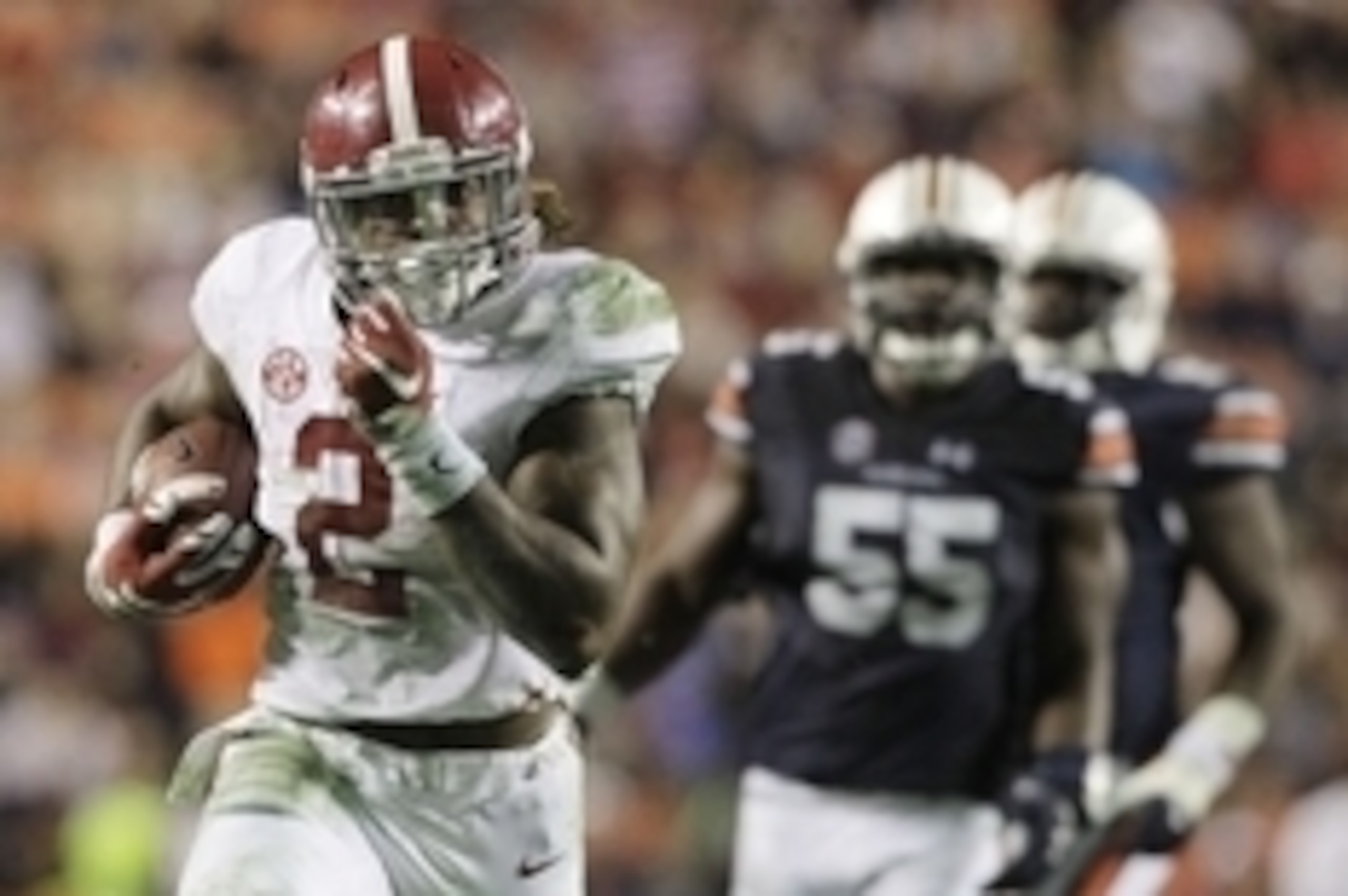Nov 28, 2015; Auburn, AL, USA; Alabama Crimson Tide running back Derrick Henry (2) races past Auburn Tigers defenders and scores a touchdown in the fourth quarter to beat the Auburn Tigers 29-13 Jordan Hare Stadium. Mandatory Credit: John Reed-USA TODAY S