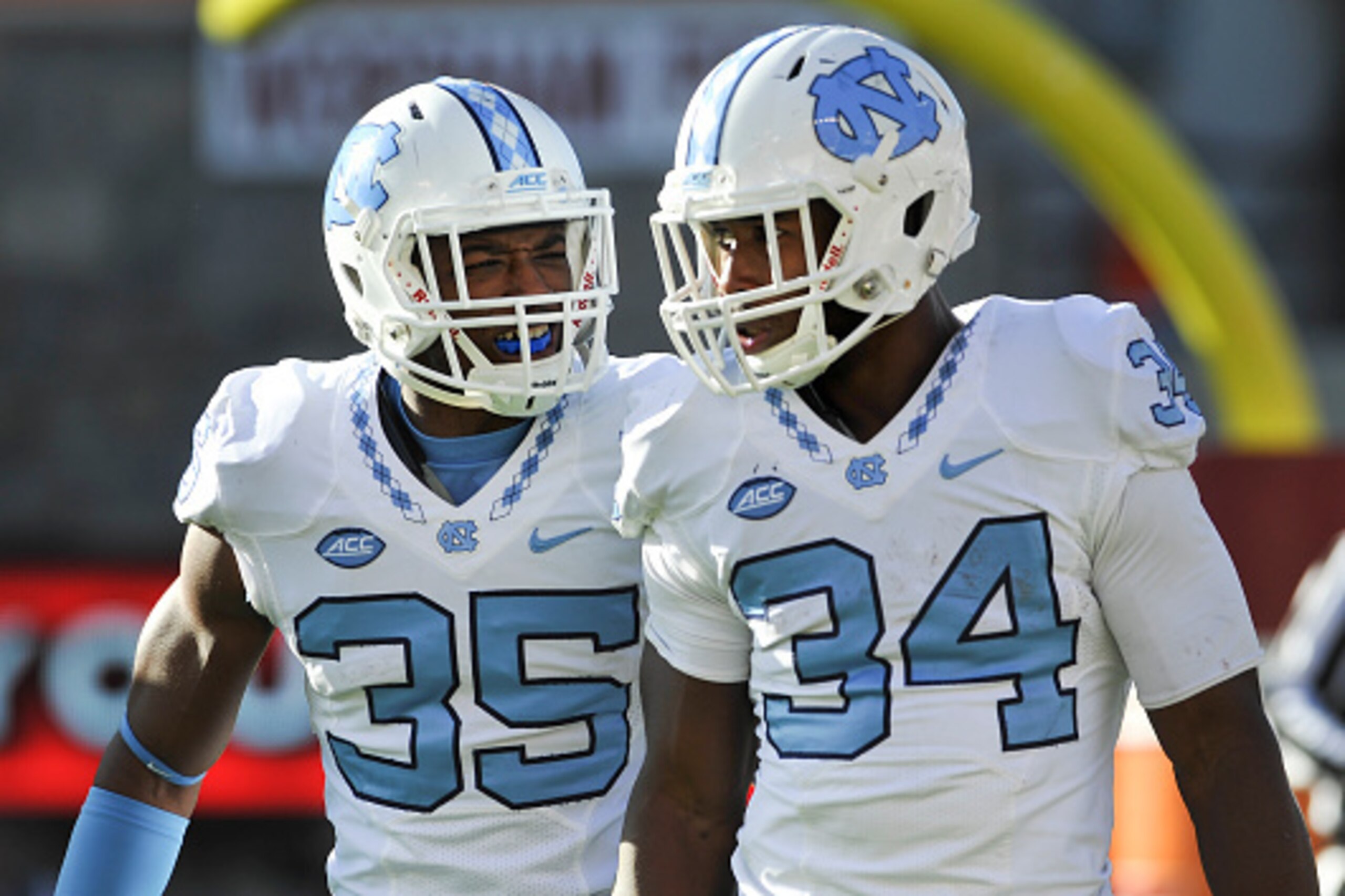 BLACKSBURG, VA - NOVEMBER 21: Wide receiver Damien Washington #35 of the North Carolina Tar Heels reacts with running back Elijah Hood #34 following his touchdown run against the Virginia Tech Hokies in the second half on November 21, 2015 in Blacksburg, 