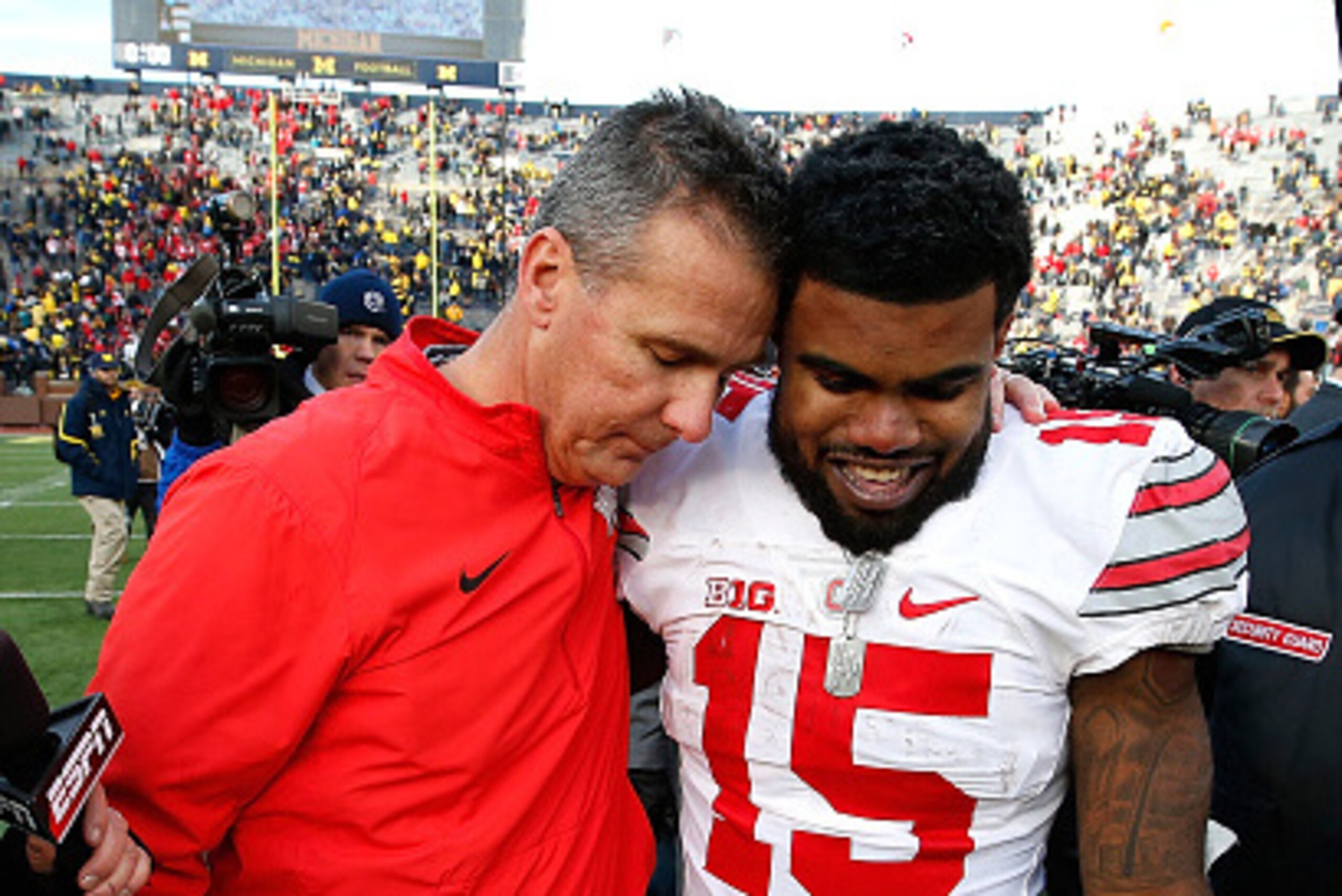 ANN ARBOR, MI - NOVEMBER 28:  Head coach Urban Meyer of the Ohio State Buckeyes celebrates with Ezekiel Elliott #15 after a 42-13 Ohio State win over the Michigan Wolverines at Michigan Stadium on November 28, 2015 in Ann Arbor, Michigan.  (Photo by Grego