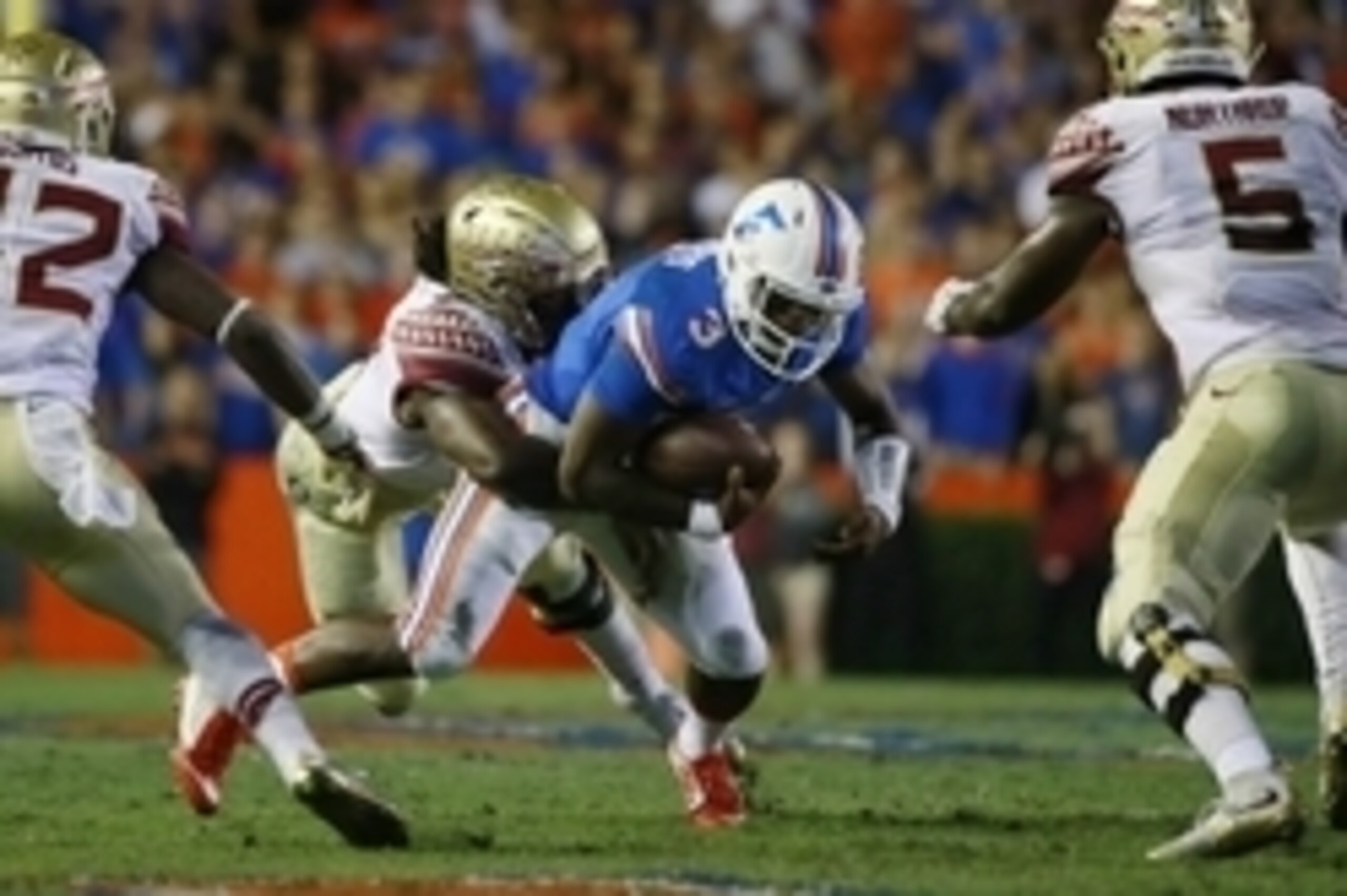 Nov 28, 2015; Gainesville, FL, USA; Florida State Seminoles defensive end Josh Sweat (9) tackles Florida Gators quarterback Treon Harris (3) during the first quarter at Ben Hill Griffin Stadium. Mandatory Credit: Kim Klement-USA TODAY Sports