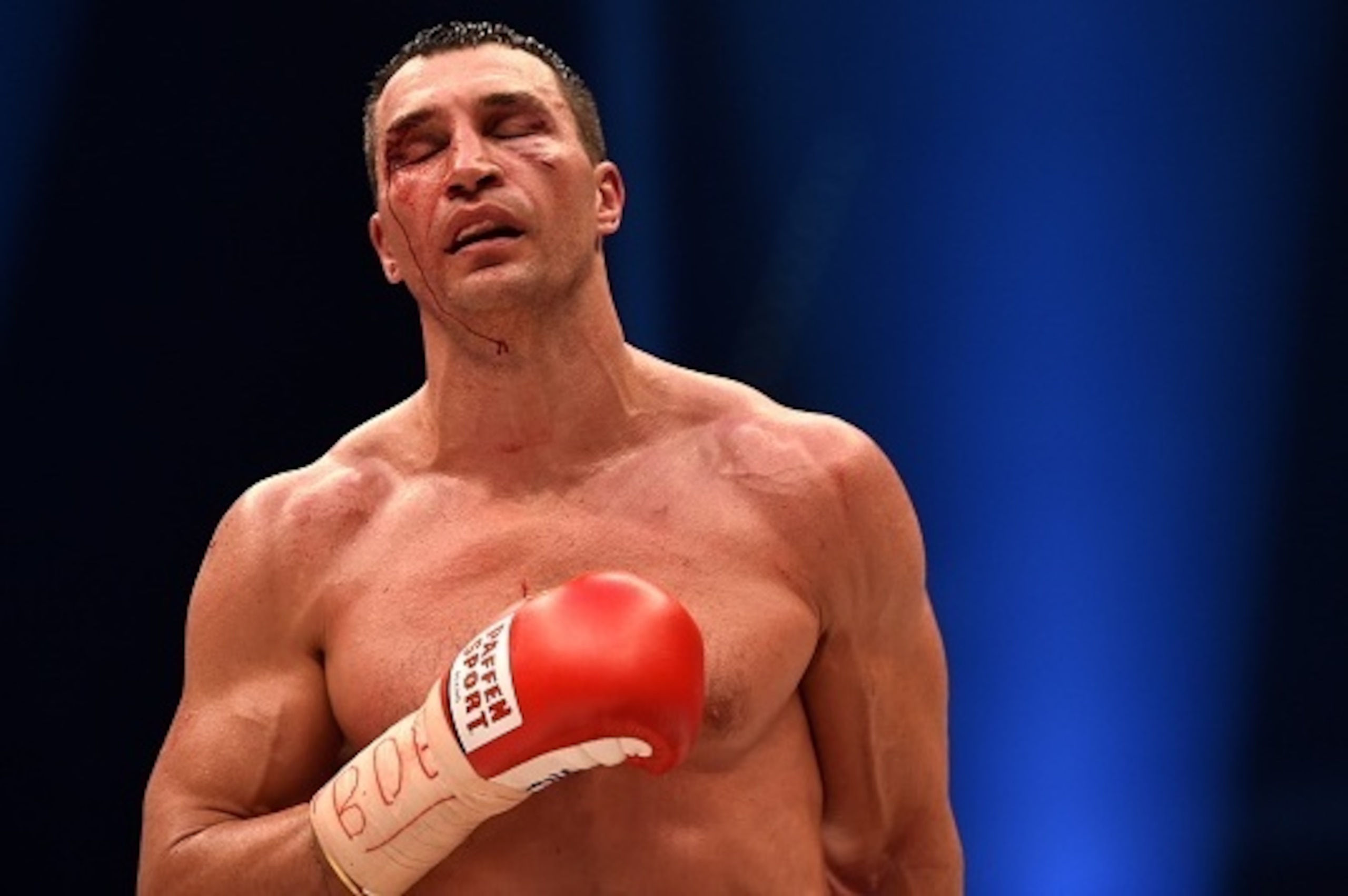 A bloodied world heavyweight boxing champion Wladimir Klitschko of Ukraine returns to his corner between rounds against Britain's Tyson Fury during their  WBA, IBF, WBO and IBO title bout in Duesseldorf, western Germany, on November 28, 2015.   Fury dethr