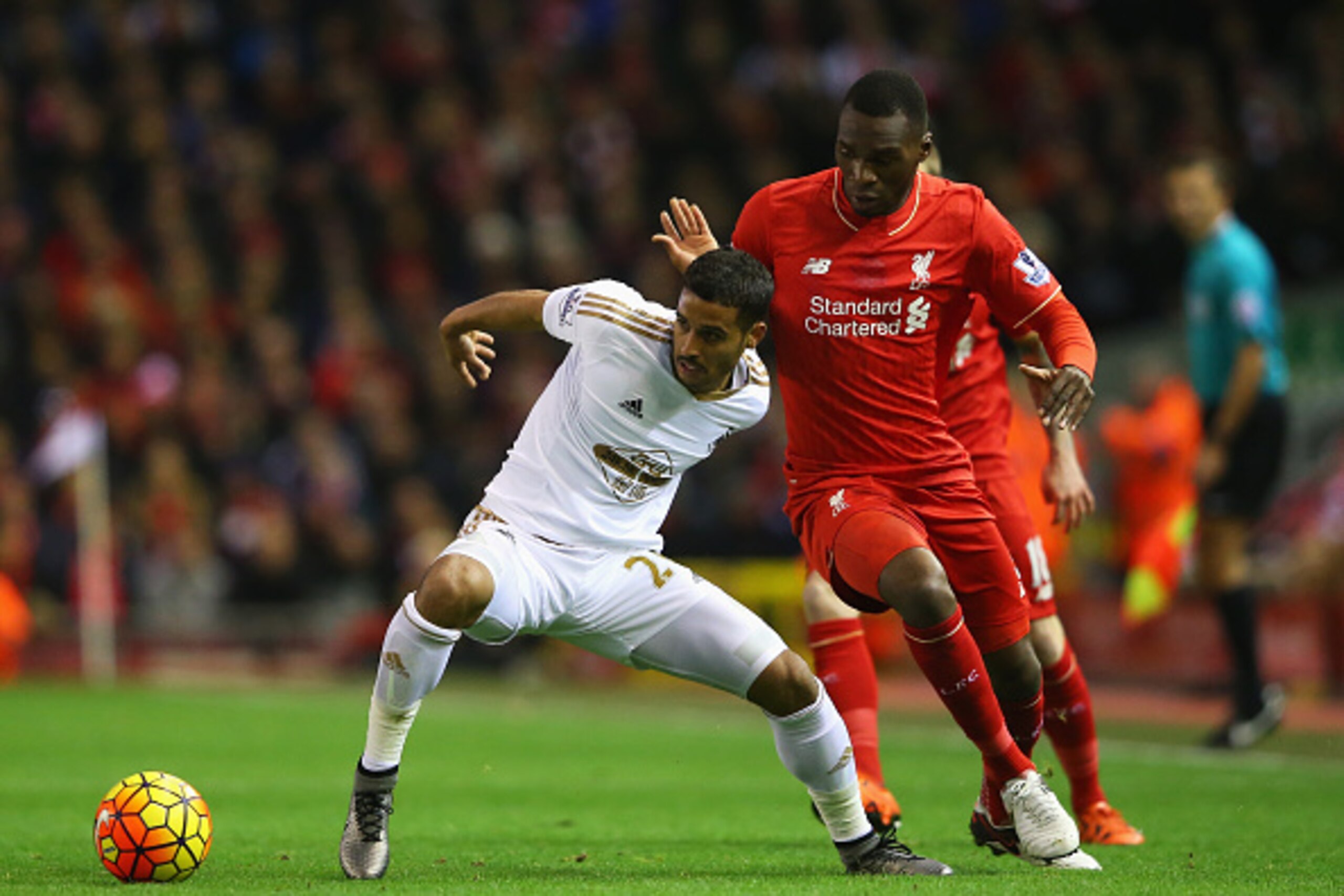 LIVERPOOL, ENGLAND - NOVEMBER 29:  Kyle Naughton of Swansea City holds off Christian Benteke of Liverpool during the Barclays Premier League match between Liverpool and Swansea City at Anfield on November 29, 2015 in Liverpool, England.  (Photo by Alex Li