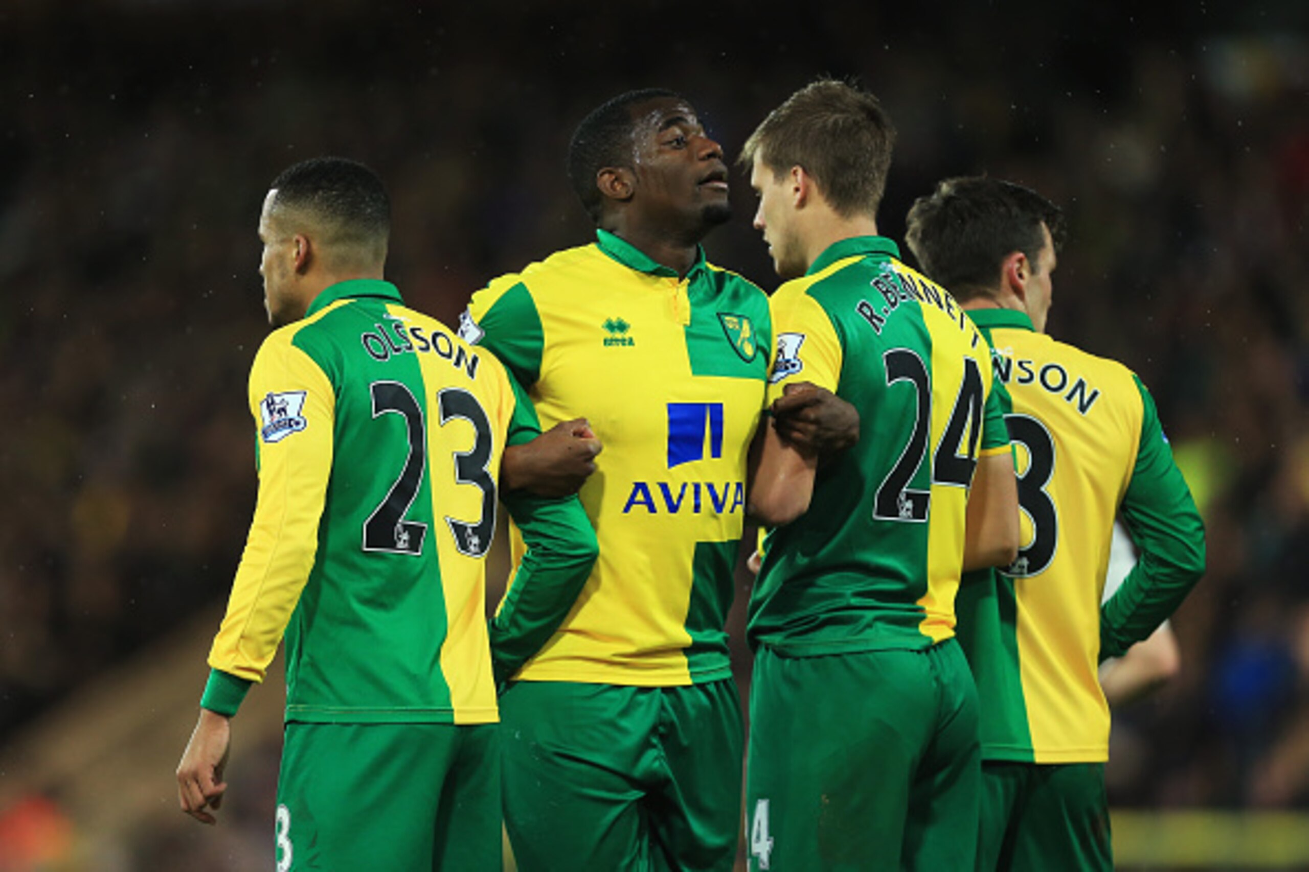 NORWICH, ENGLAND - NOVEMBER 29:  (L-R) Martin Olsson, Sebastien Bassong, Ryan Bennett and Jonathan Howson of Norwich City form a defensive wall during the Barclays Premier League match between Norwich City and Arsenal at Carrow Road on November 29, 2015 i
