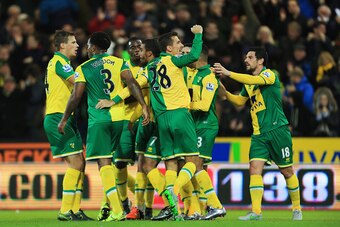NORWICH, ENGLAND - NOVEMBER 29:  Lewis Grabban of Norwich City (7) celebrates team mates as he scores their first and equalising goal during the Barclays Premier League match between Norwich City and Arsenal at Carrow Road on November 29, 2015 in Norwich,