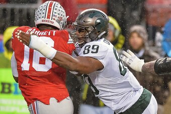 COLUMBUS, OH - NOVEMBER 21:  Shilique Calhoun #89 of the Michigan State Spartans sacks quarterback J.T. Barrett #16 of the Ohio State Buckeyes at Ohio Stadium on November 21, 2015 in Columbus, Ohio.  (Photo by Jamie Sabau/Getty Images)