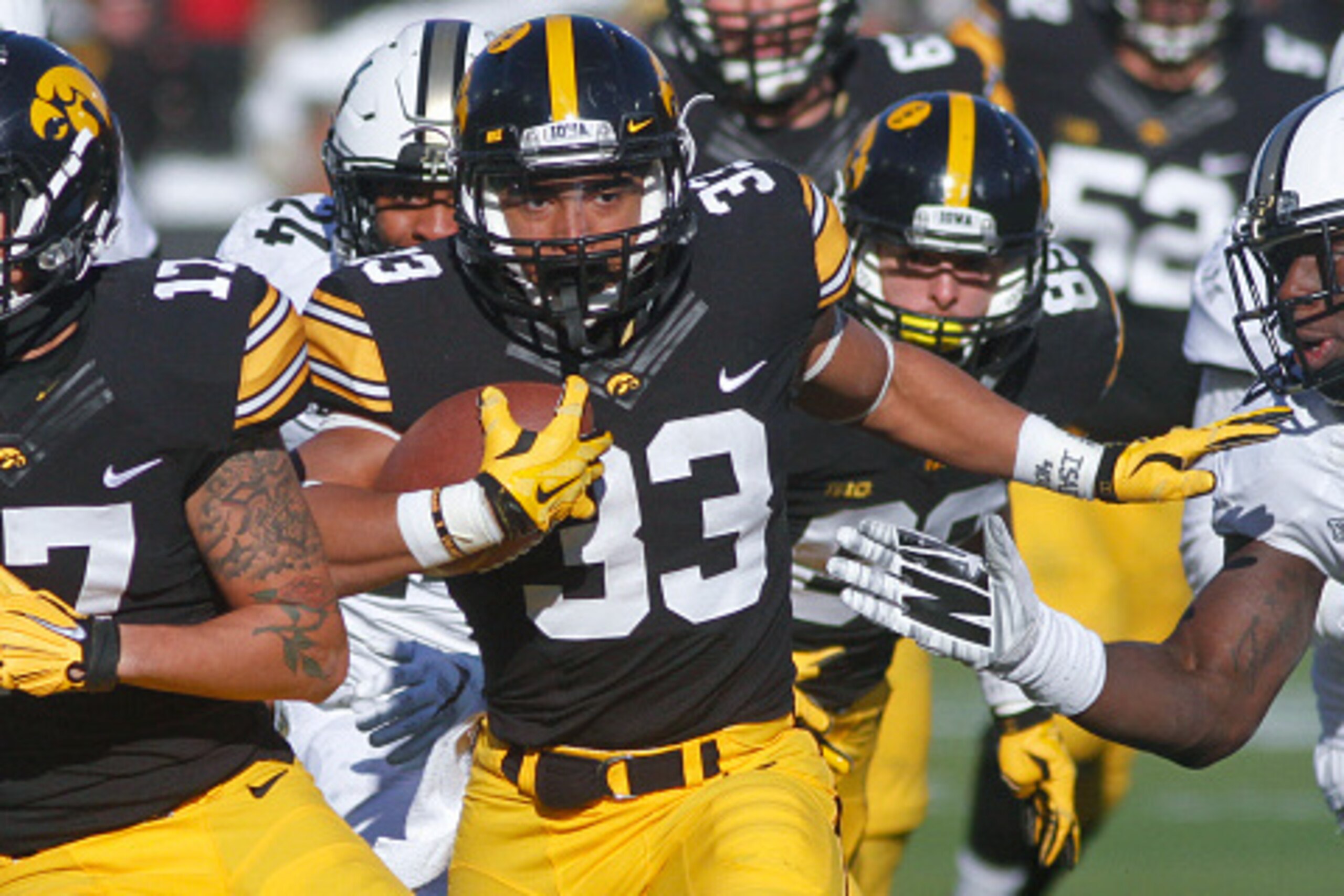 IOWA CITY, IA - NOVEMBER 21: Runningback Jordan Canzeri #33 of the Iowa Hawkeyes runs up the field in the second half in front of linebacker Danny Ezechukwu #6 of the Purdue Boilermakers on November 21, 2015 at Kinnick Stadium, in Iowa City, Iowa. (Photo 