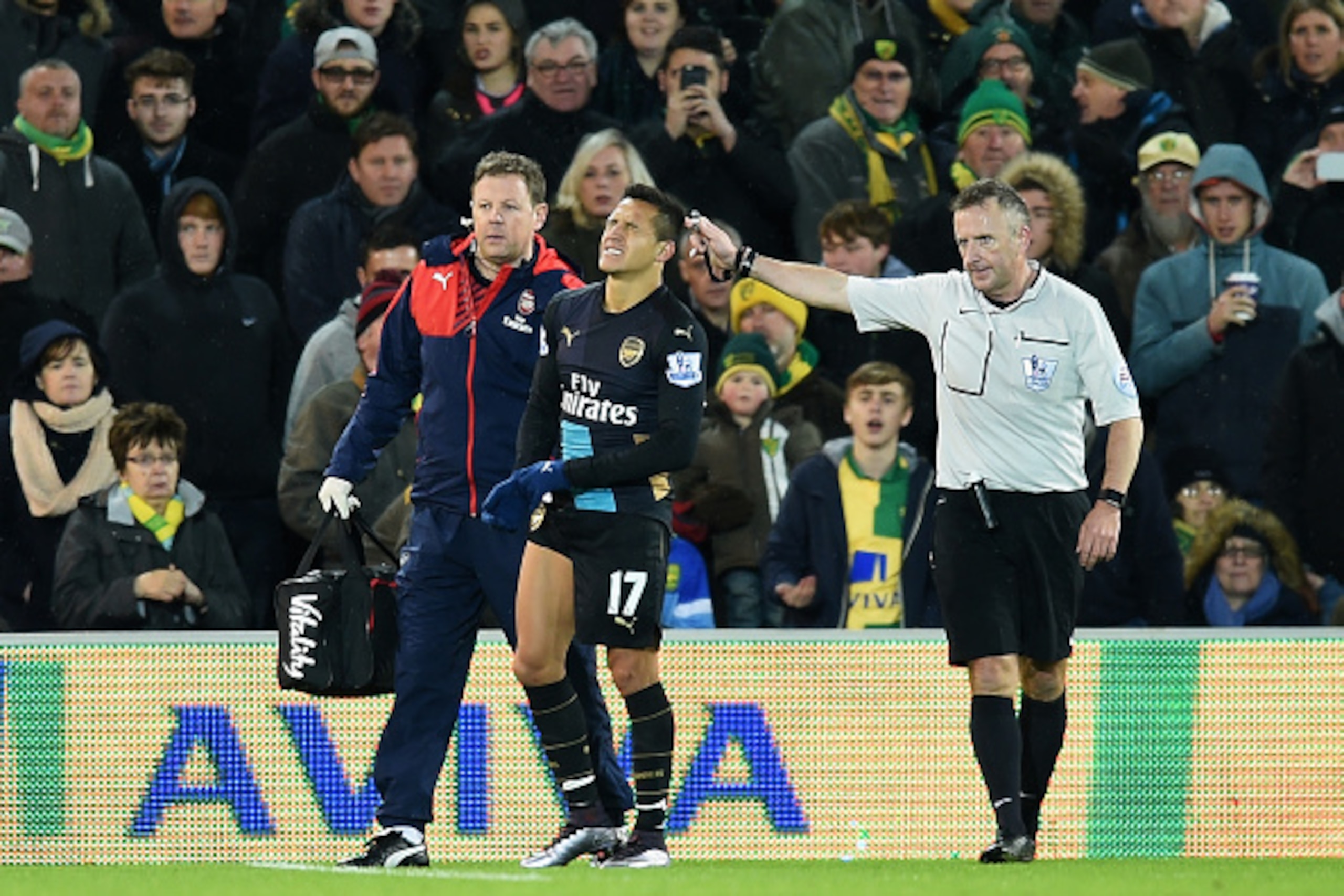 NORWICH, ENGLAND - NOVEMBER 29:  An injured Alexis Sanchez of Arsenal (17) is given assistance during the Barclays Premier League match between Norwich City and Arsenal at Carrow Road on November 29, 2015 in Norwich, England.  (Photo by Michael Regan/Gett