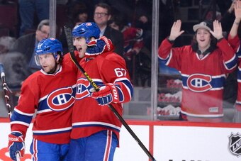 MONTREAL, CANADA - FEBRUARY 21:  Max Pacioretty #67 of the Montreal Canadiens celebrates his second-period goal with teammate David Desharnais #51 during the NHL game against the New York Islanders at the Bell Centre on February 21, 2013 in Montreal, Queb