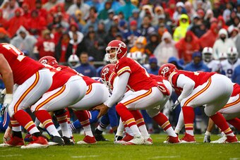 KANSAS CITY, MO - NOVEMBER 29: Alex Smith #11 of the Kansas City Chiefs prepares to take the snap at Arrowhead Stadium during the first quarter of the game against the Buffalo Bills on November 29, 2015 in Kansas City, Missouri. (Photo by Jamie Squire/Get