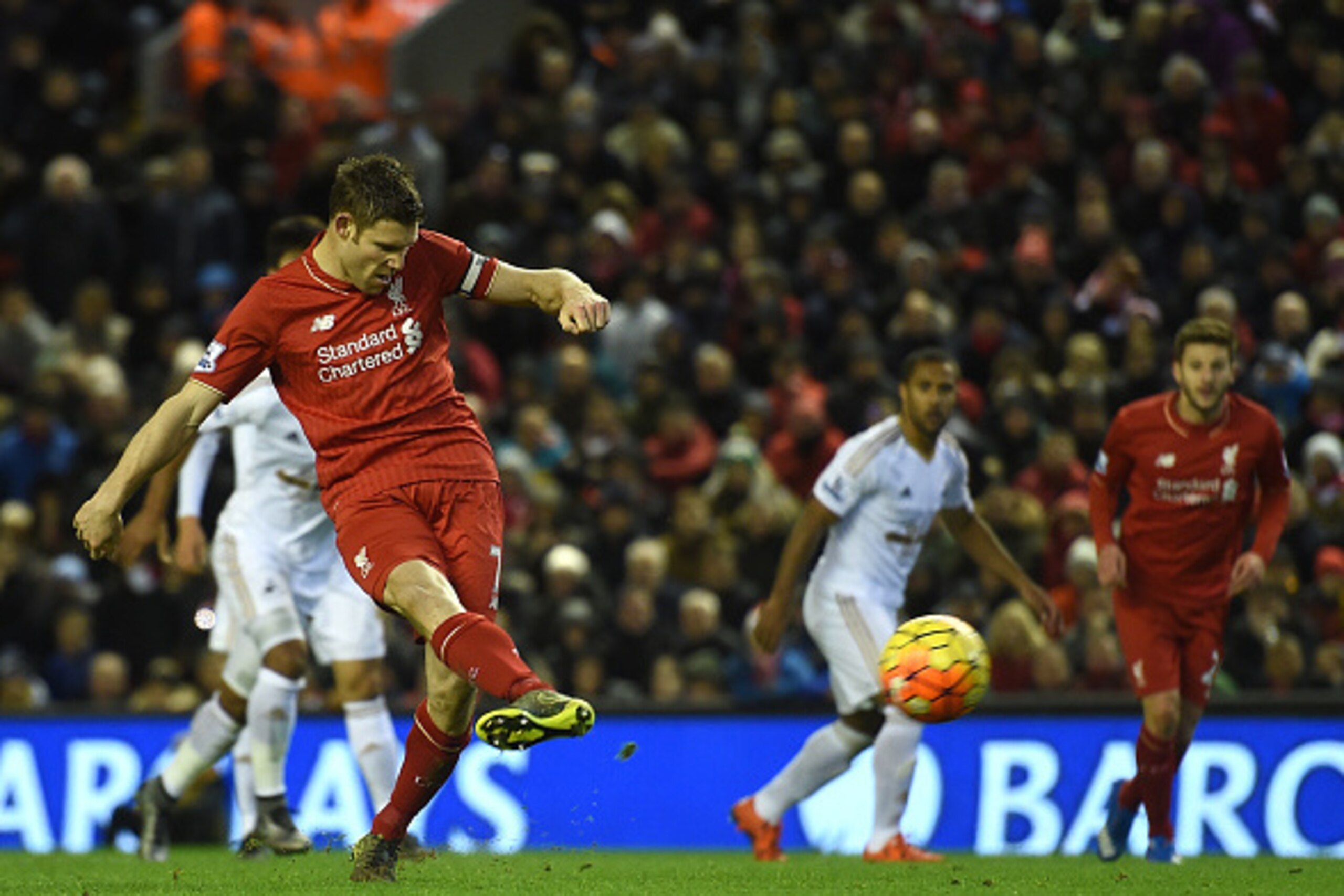 Liverpool's English midfielder James Milner scores the opening goal from the penalty spot during the English Premier League football match between Liverpool and Swansea City at the Anfield stadium in Liverpool, north-west England on November 29, 2015.   A