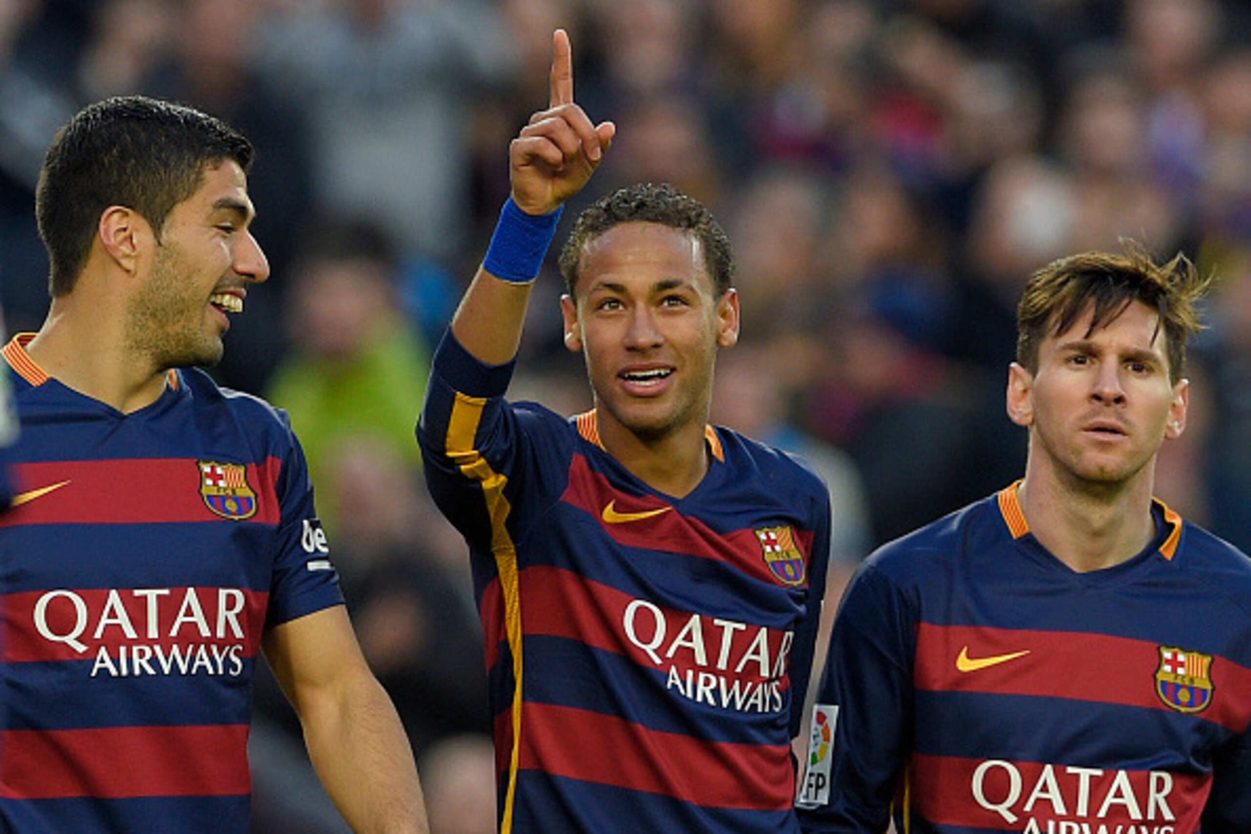 Barcelona's Brazilian forward Neymar (C) celebrates with Barcelona's Uruguayan forward Luis Suarez (L) and Barcelona's Argentinian forward Lionel Messi after scoring their third goal during the Spanish league football match FC Barcelona vs Real Sociedad d