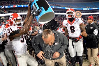 CHARLOTTE, NC - DECEMBER 30:  Chris Conley #31 of the Georgia Bulldogs gives coach Mark Richt a celebratory dunking after a win over the Louisville Cardinals in the Belk Bowl at Bank of America Stadium on December 30, 2014 in Charlotte, North Carolina. Ge