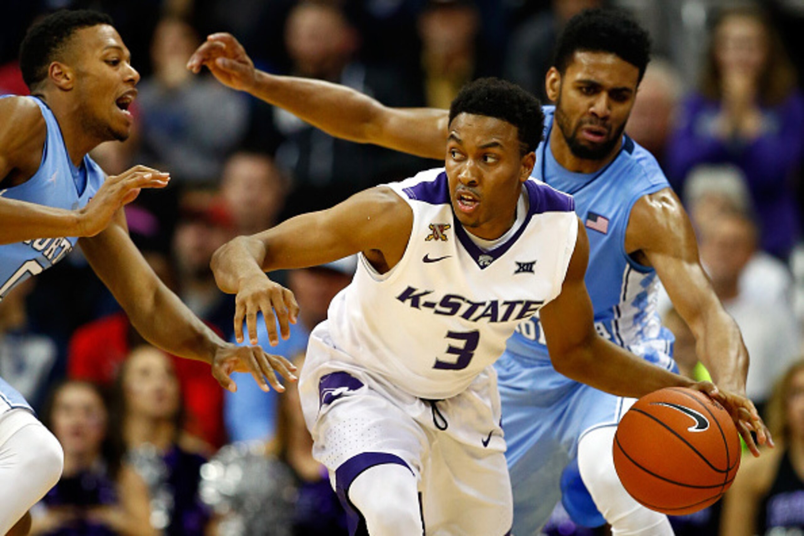 KANSAS CITY, MO - NOVEMBER 24:  Kamau Stokes #3 of the Kansas State Wildcats controls the ball as Nate Britt #0 and Joel Berry II #2 of the North Carolina Tar Heels defend during the CBE Hall Of Fame Classic at Sprint Center on November 24, 2015 in Kansas