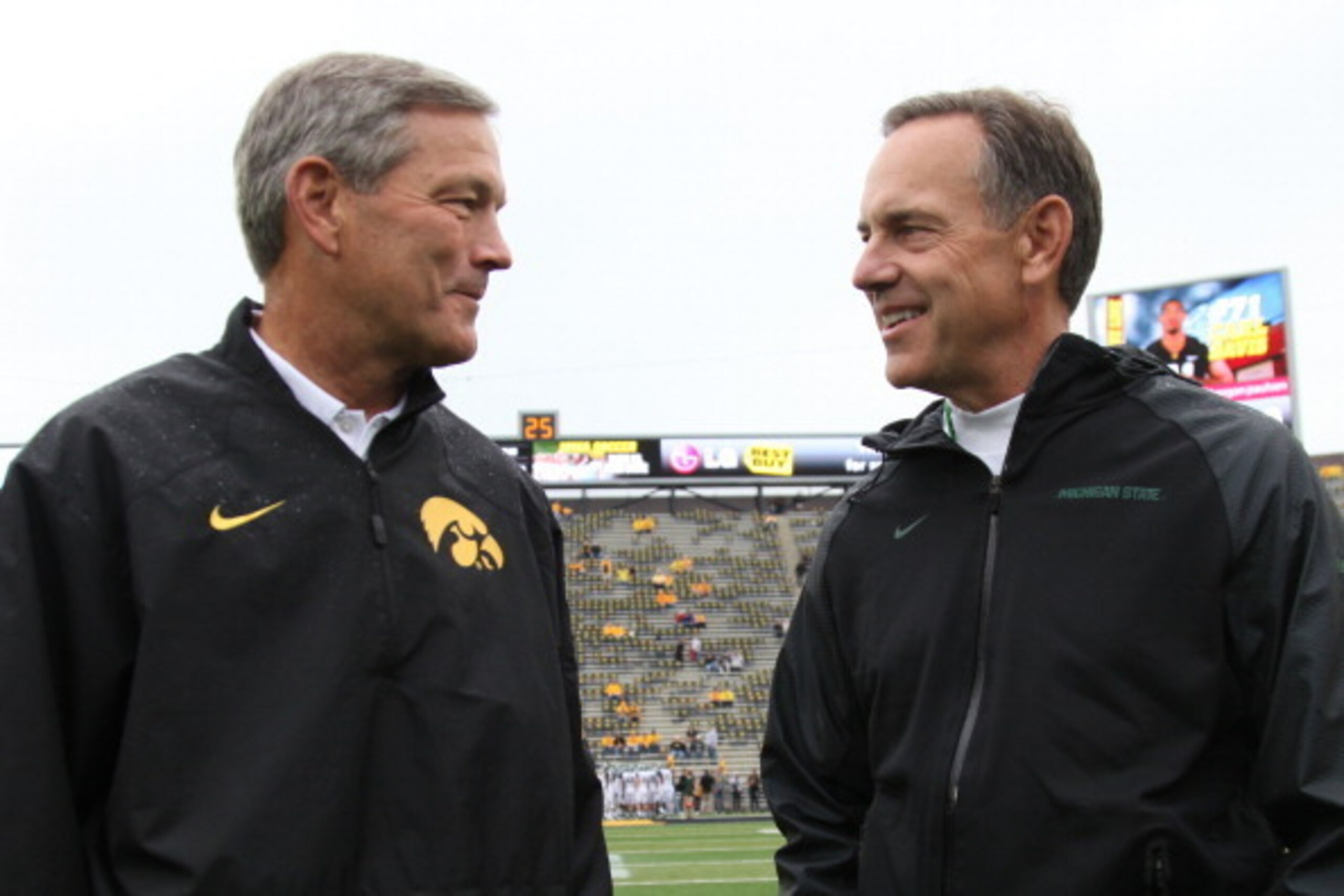 IOWA CITY, IOWA - OCTOBER 5:  Head coach Kirk Ferentz of the Iowa Hawkeyes visits with head coach Mark Dantonio of the Michigan State Spartans before their match-up on October 5, 2013 at Kinnick Stadium in Iowa City, Iowa. Michigan State won 26-14. (Photo