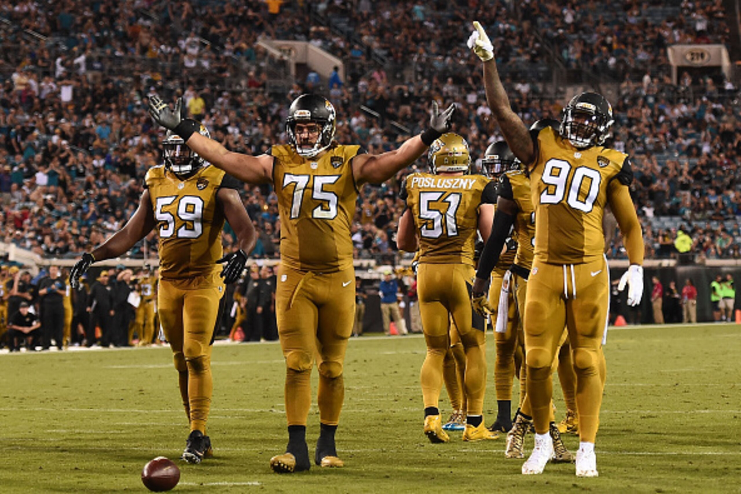 JACKSONVILLE, FL - NOVEMBER 19:  Ryan Davis #59, Jared Odrick #75 and Andre Branch #90 of the Jacksonville Jaguars encourage the crowd during a game against the Tennessee Titans at EverBank Field on November 19, 2015 in Jacksonville, Florida.  Jacksonvill