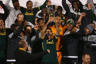 FRISCO, TX - NOVEMBER 29:  Diego Valeri #8 of Portland Timbers raises the MLS Western Conference trophy after defeating FC Dallas in the Western Conference Finals-Leg 2 of the MLS playoffs at Toyota Stadium on November 29, 2015 in Frisco, Texas.  (Photo b