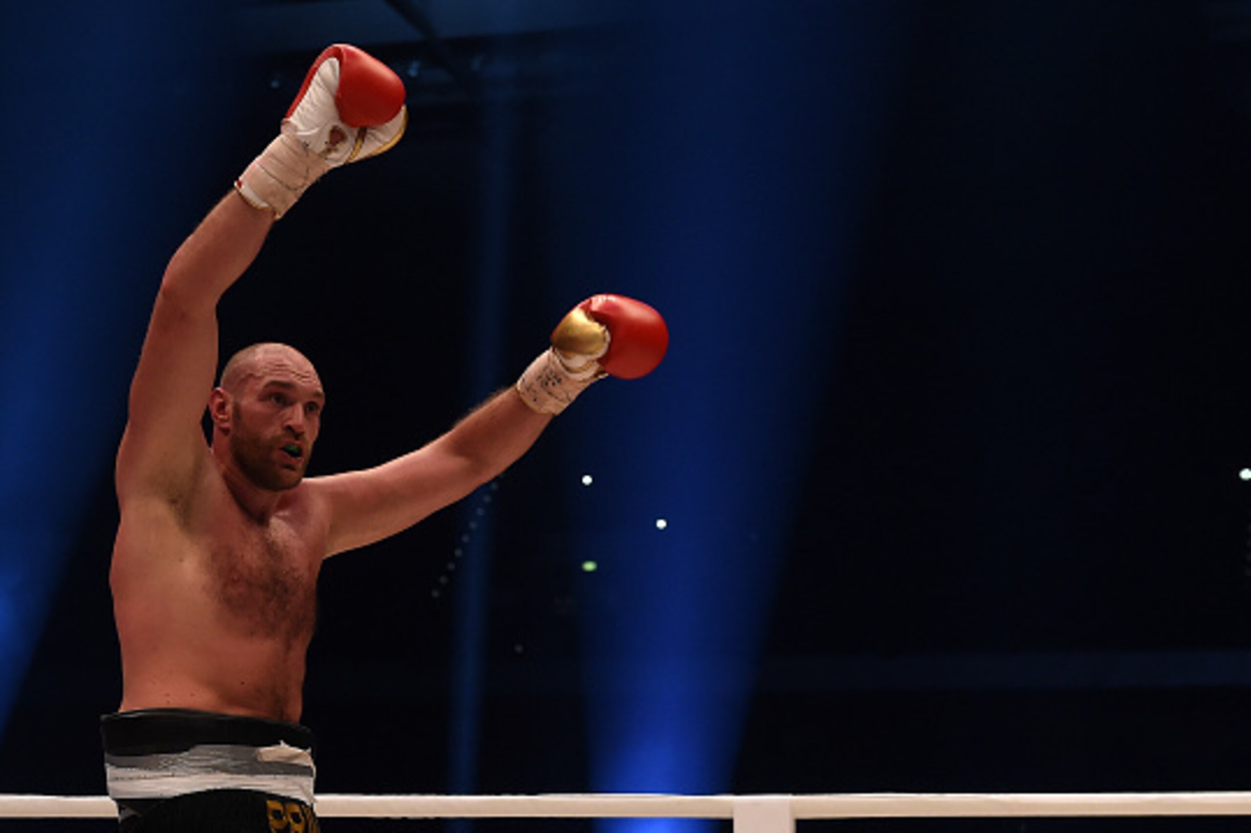 British Tyson Fury celebrates after the WBA, IBF, WBO and IBO title bout against Ukrainian world heavyweight boxing champion Wladimir Klitschko in Duesseldorf, western Germany, on November 28, 2015. Fury won the fight after 12 Rounds of Boxing. AFP PHOTO 