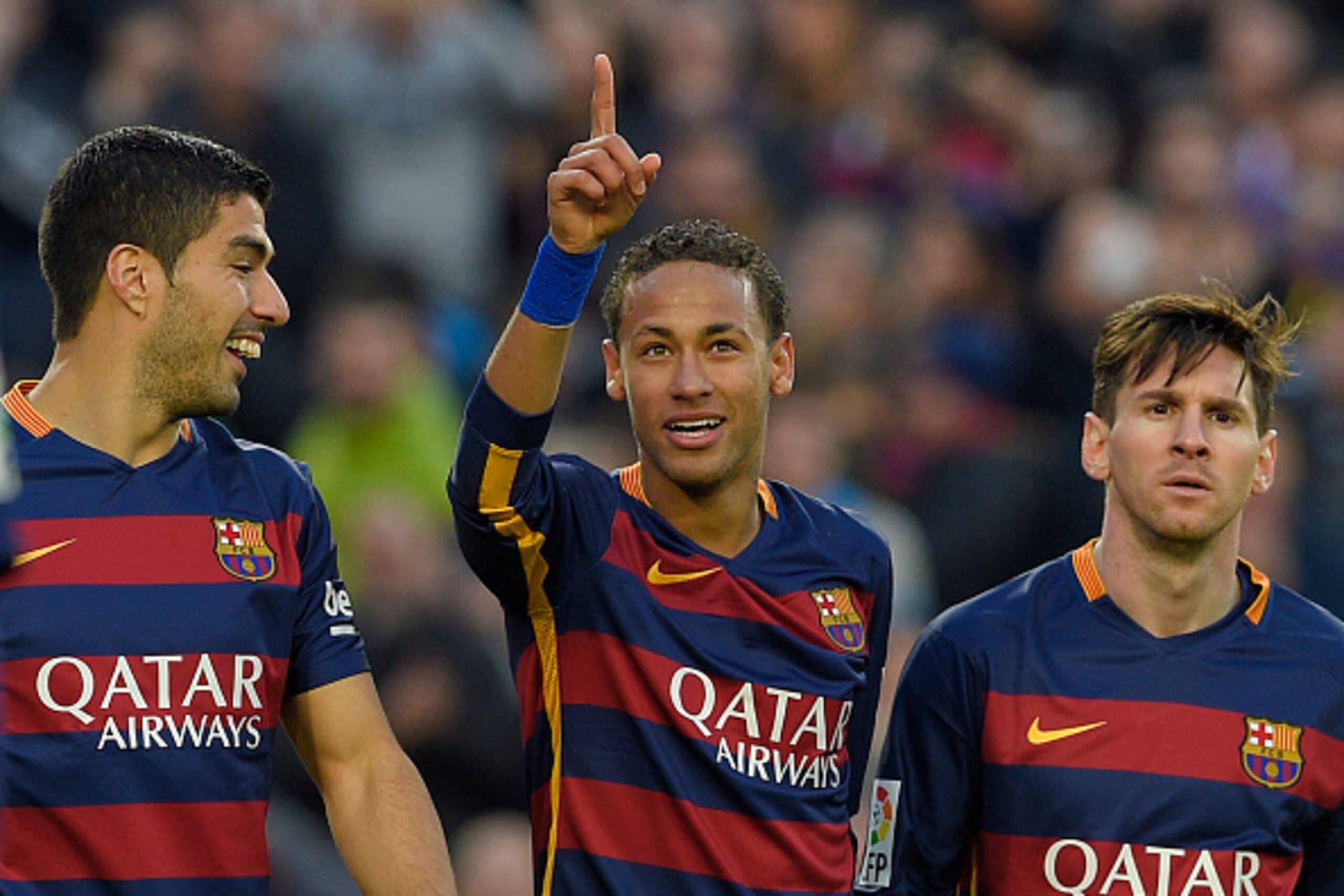 Barcelona's Brazilian forward Neymar (C) celebrates with Barcelona's Uruguayan forward Luis Suarez (L) and Barcelona's Argentinian forward Lionel Messi after scoring their third goal during the Spanish league football match FC Barcelona vs Real Sociedad d