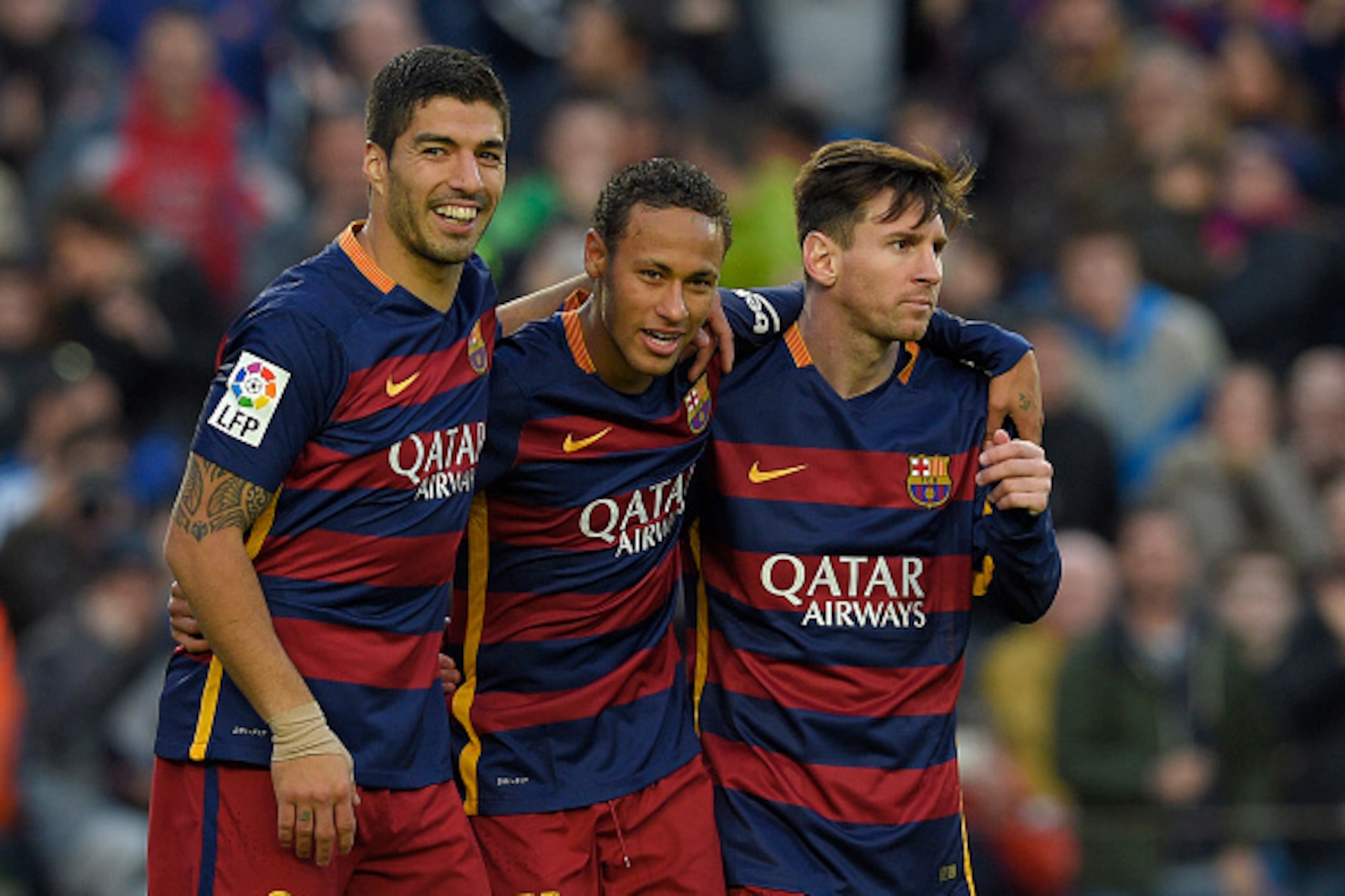 Barcelona's Brazilian forward Neymar (C) celebrates with Barcelona's Uruguayan forward Luis Suarez (L) and Barcelona's Argentinian forward Lionel Messi after scoring their third goal during the Spanish league football match FC Barcelona vs Real Sociedad d