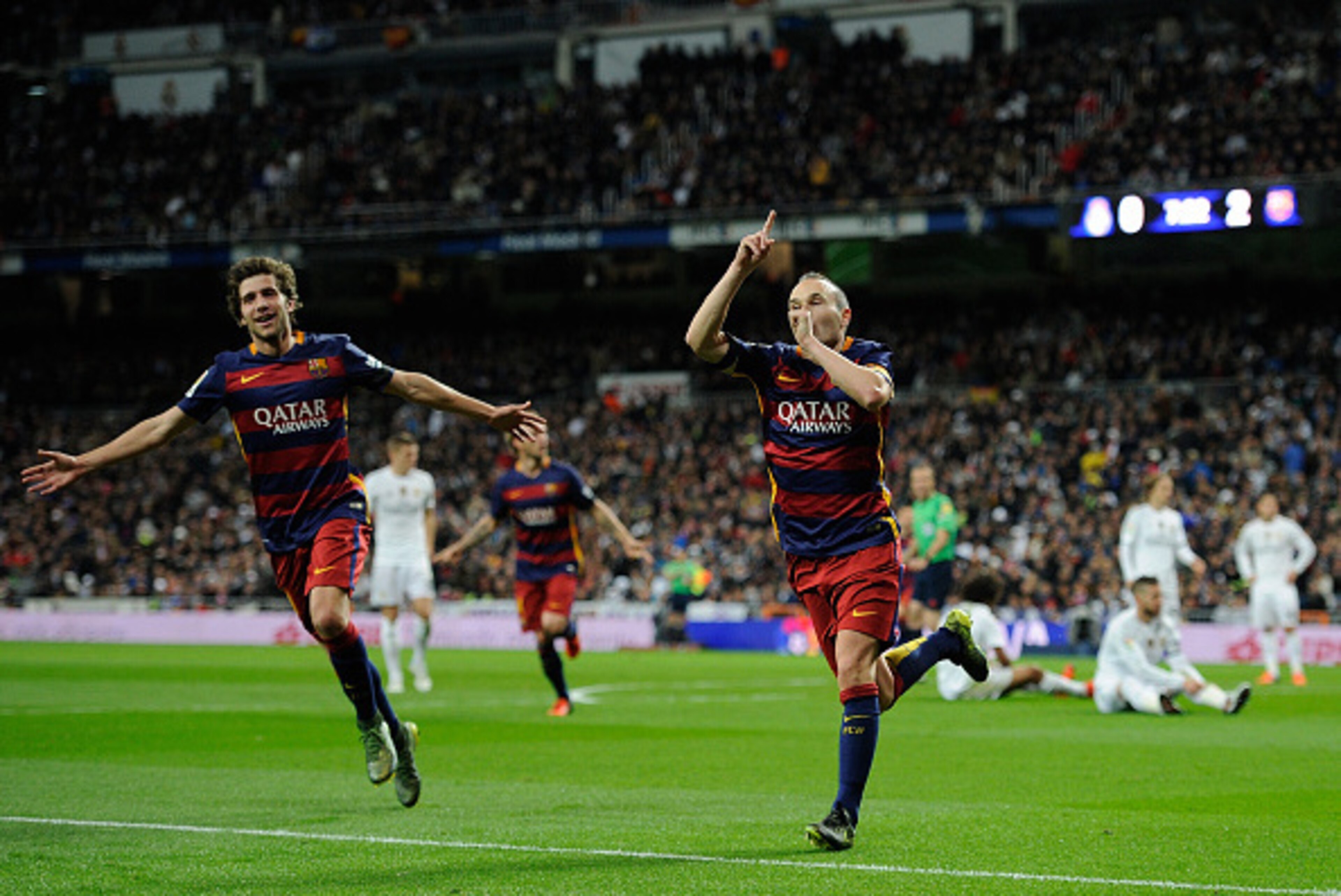 MADRID, SPAIN - NOVEMBER 21:  Andres Iniesta of FC Barcelona celebrates with Sergi Roberto after scoring his team's 3rd goal during the La Liga match between Real Madrid and Barcelona at Estadio Santiago Bernabeu on November 21, 2015 in Madrid, Spain.  (P
