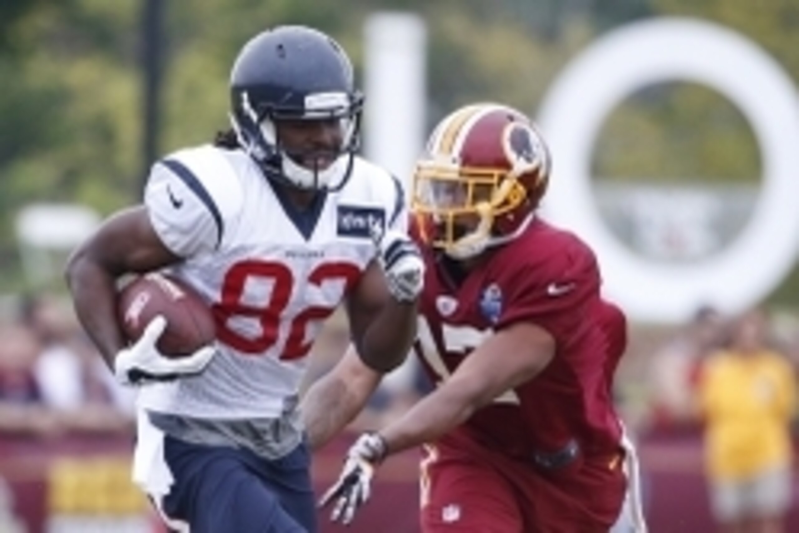 Aug 7, 2015; Richmond, VA, USA; Houston Texans wide receiver Keshawn Martin (82) carries the ball in front of Washington Redskins wide receiver Quinton Dunbar (17) during morning practice as part of day eight of training camp at Bon Secours Washington Red