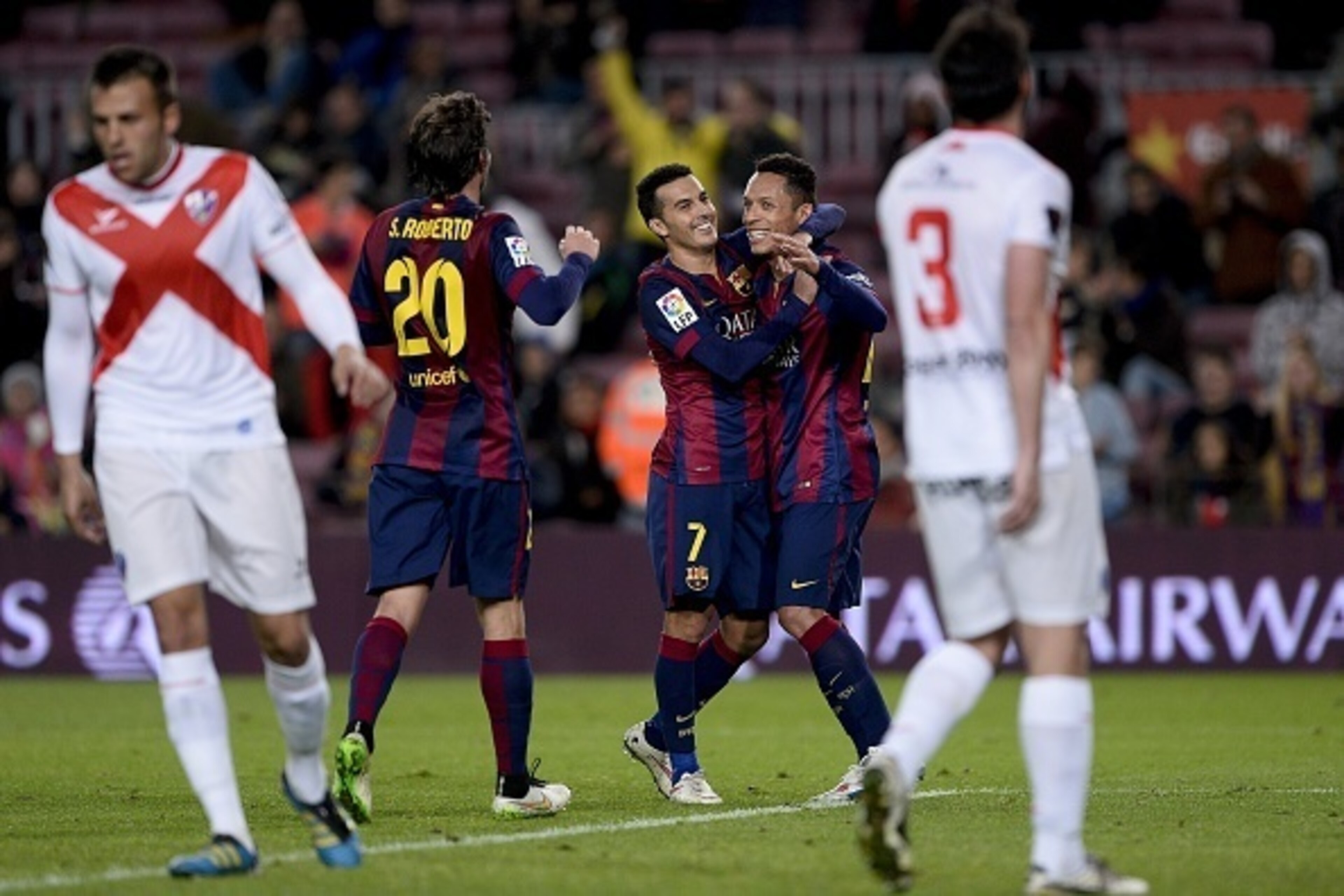 Barcelona's forward Pedro Rodriguez (C) is congratulated by his teammate Barcelona's Brazilian defender Adriano after scoring during the Spanish Copa del Rey (King's Cup) round of 32 second leg football match FC Barcelona vs S.A.D. Huesca at the Camp Nou 