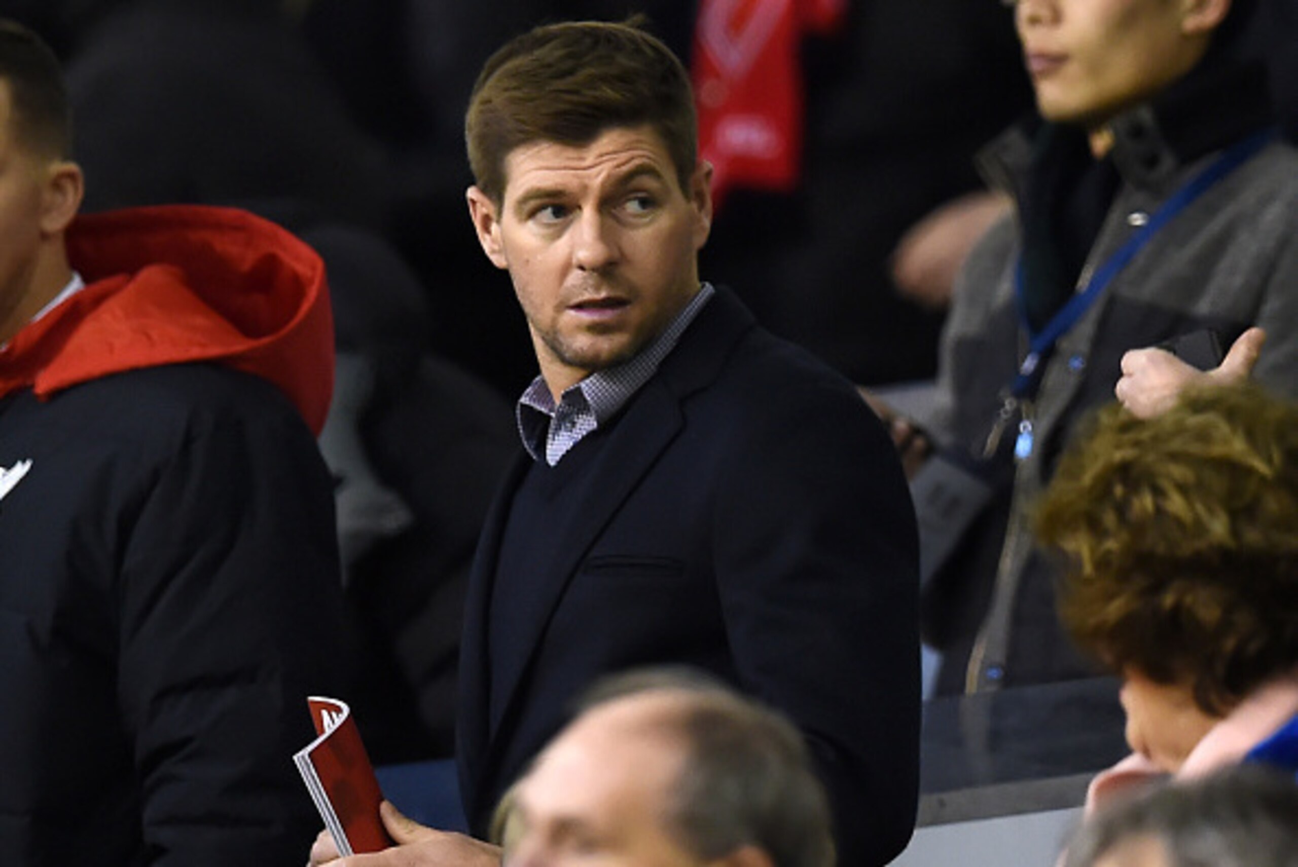 Liverpool's former captain Steven Gerrard waits for kickoff in the crowd ahead of the English Premier League football match between Liverpool and Swansea City at the Anfield stadium in Liverpool, north-west England on November 29, 2015.   AFP PHOTO / PAUL