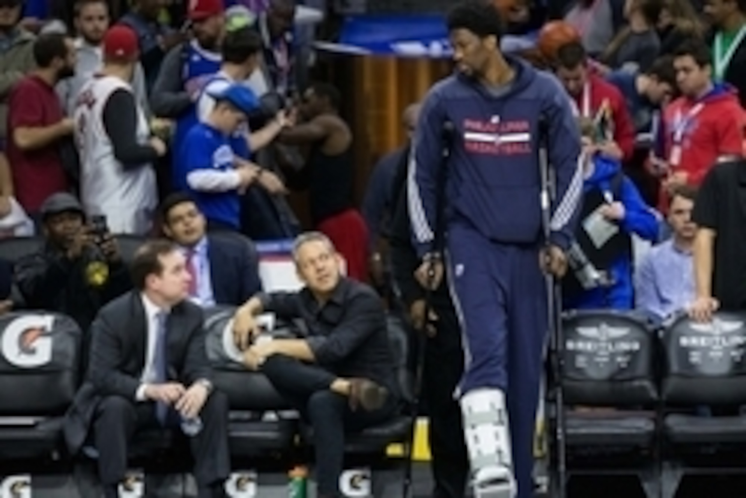 Nov 2, 2015; Philadelphia, PA, USA; Philadelphia 76ers general manager Sam Hinkie (far left) watches as center Joel Embiid (21) walks out of the tunnel on crutches prior to a game against the Cleveland Cavaliers at Wells Fargo Center. Mandatory Credit: Bi