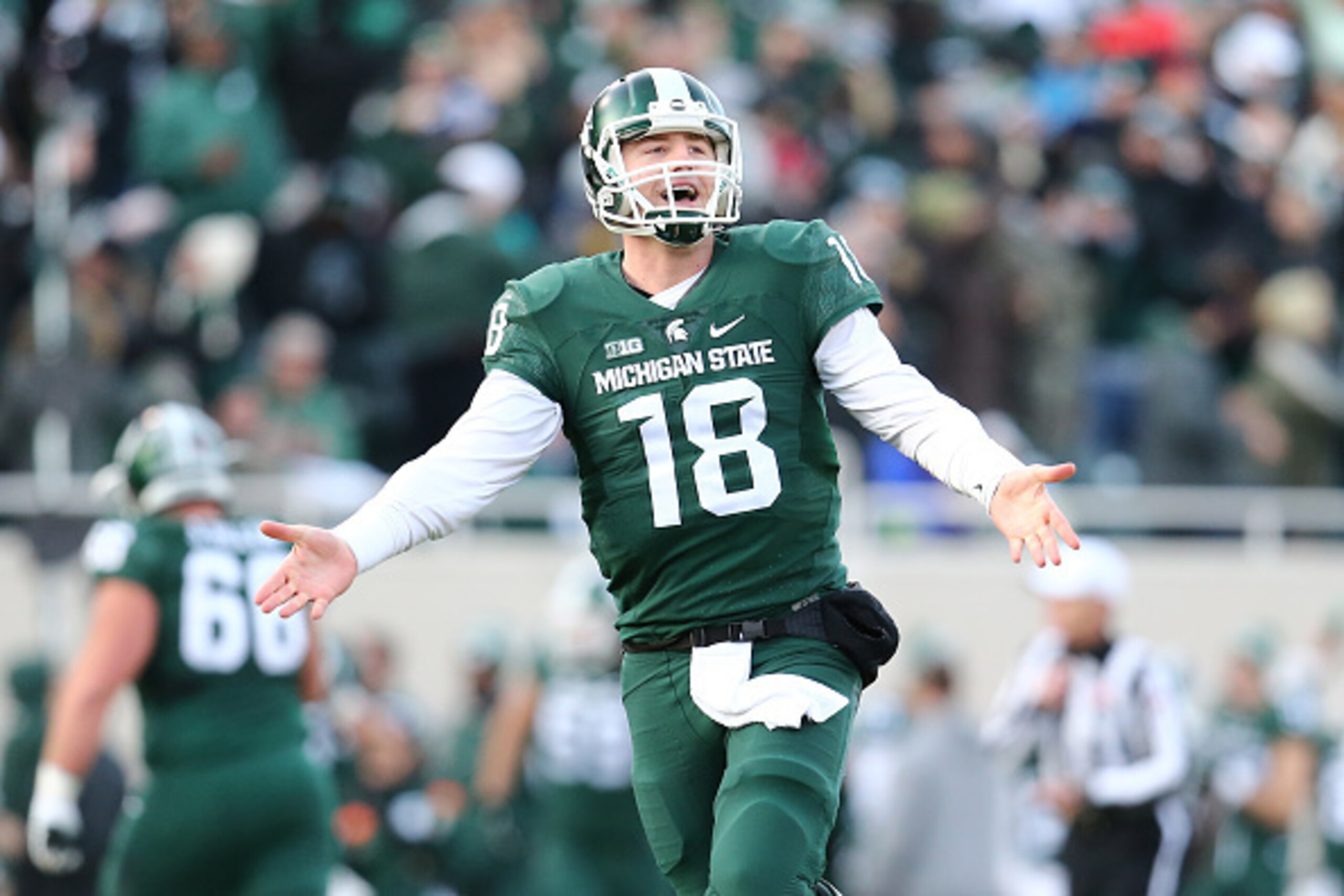 EAST LANSING, MI - NOVEMBER 28:  Connor Cook #18 of the Michigan State Spartans celebrates after throwing a touchdown pass in the first quarter at Spartan Stadium  on November 28, 2015 in East Lansing, Michigan. (Photo by Rey Del Rio/Getty Images)
