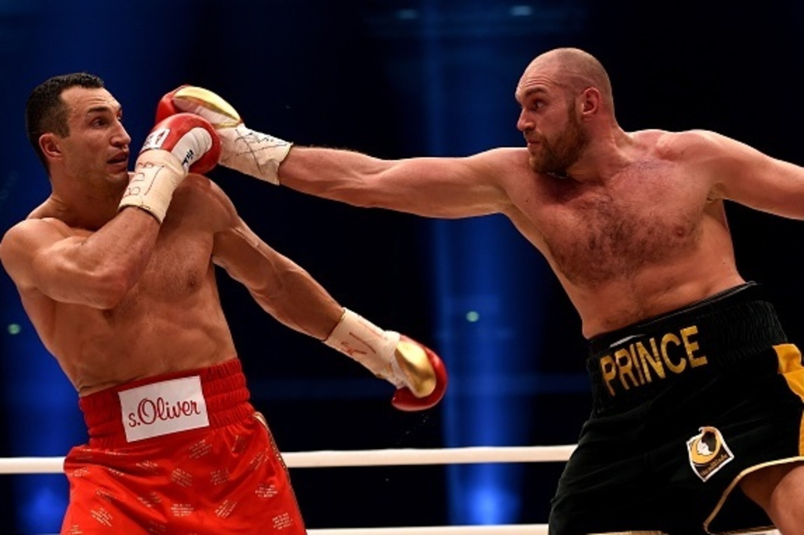 World heavyweight boxing champion Wladimir Klitschko (L) of Ukraine defends against Britain's Tyson Fury during their  WBA, IBF, WBO and IBO title bout in Duesseldorf, western Germany, on November 28, 2015.   Fury dethroned  Klitschko in a 12round decisio