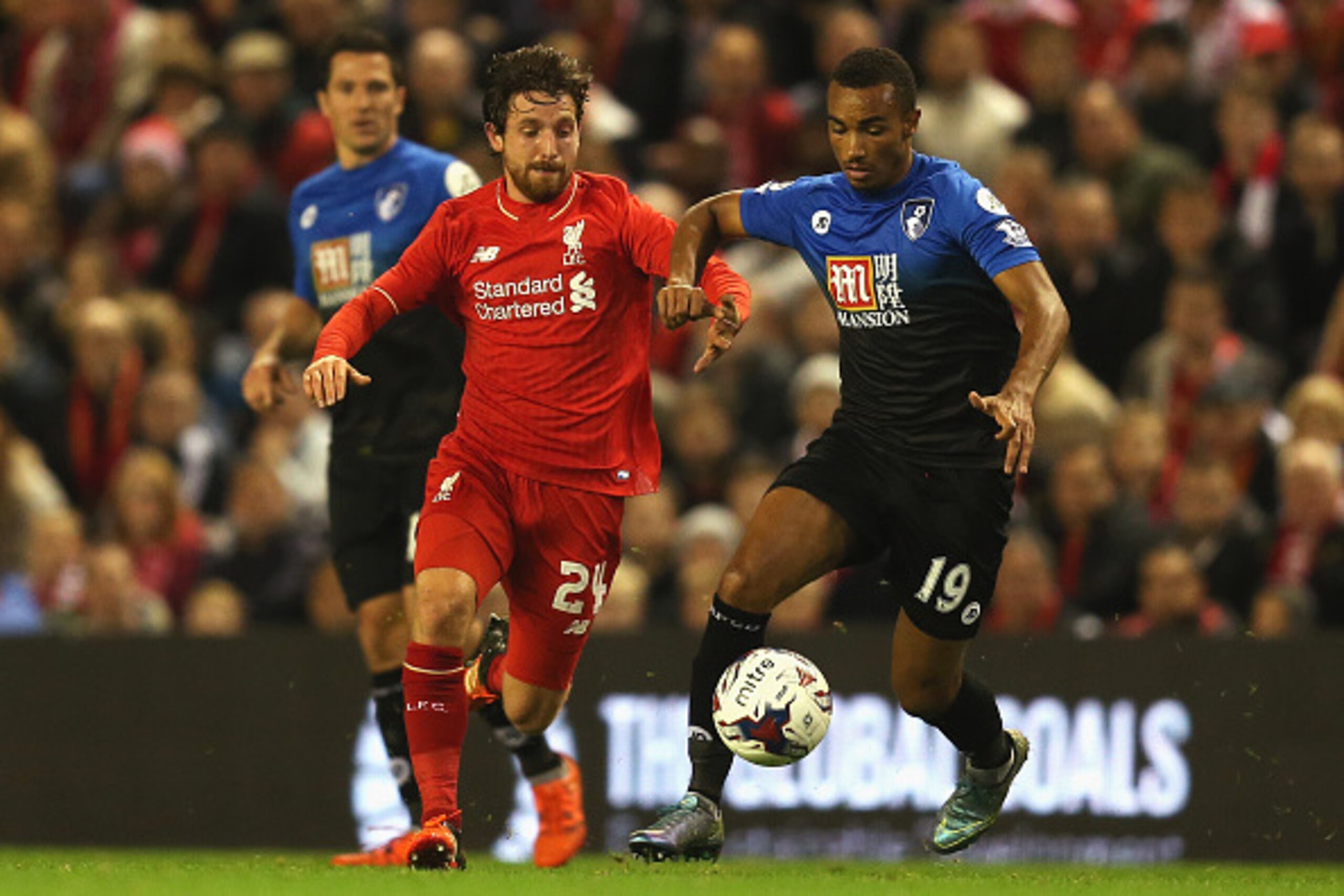 LIVERPOOL, ENGLAND - OCTOBER 28: Joe Allen of Liverpool takes on Junior Stanislas of Bournemouth during the Capital One Cup Fourth Round match between Liverpool and AFC Bournemouth at Anfield on October 28, 2015 in Liverpool, England.  (Photo by Chris Bru