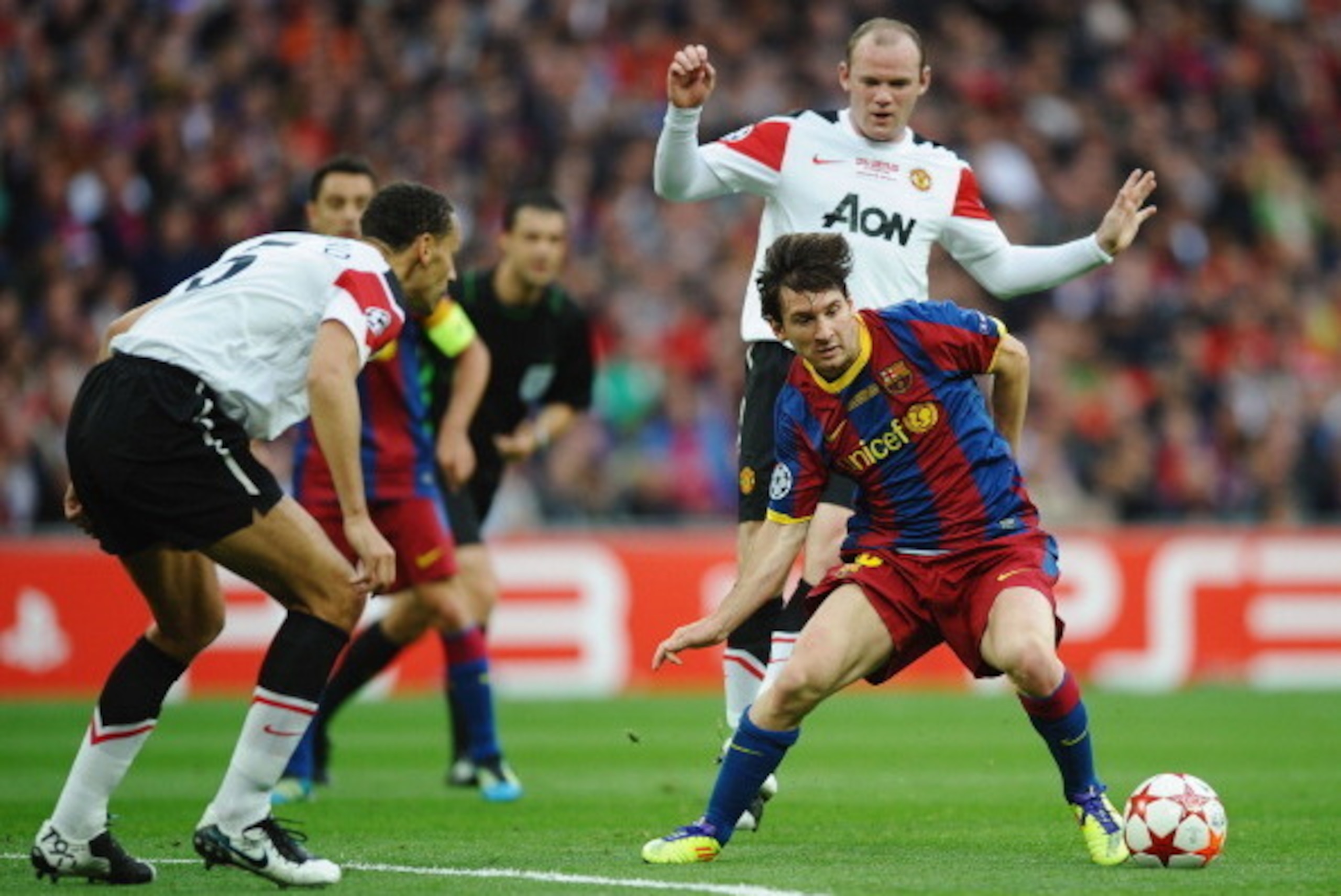 LONDON, ENGLAND - MAY 28:  Lionel Messi of FC Barcelona (R) in action against Rio Ferdinand (L) and Wayne Rooney (back) of Manchester United during the UEFA Champions League final between FC Barcelona and Manchester United FC at Wembley Stadium on May 28,