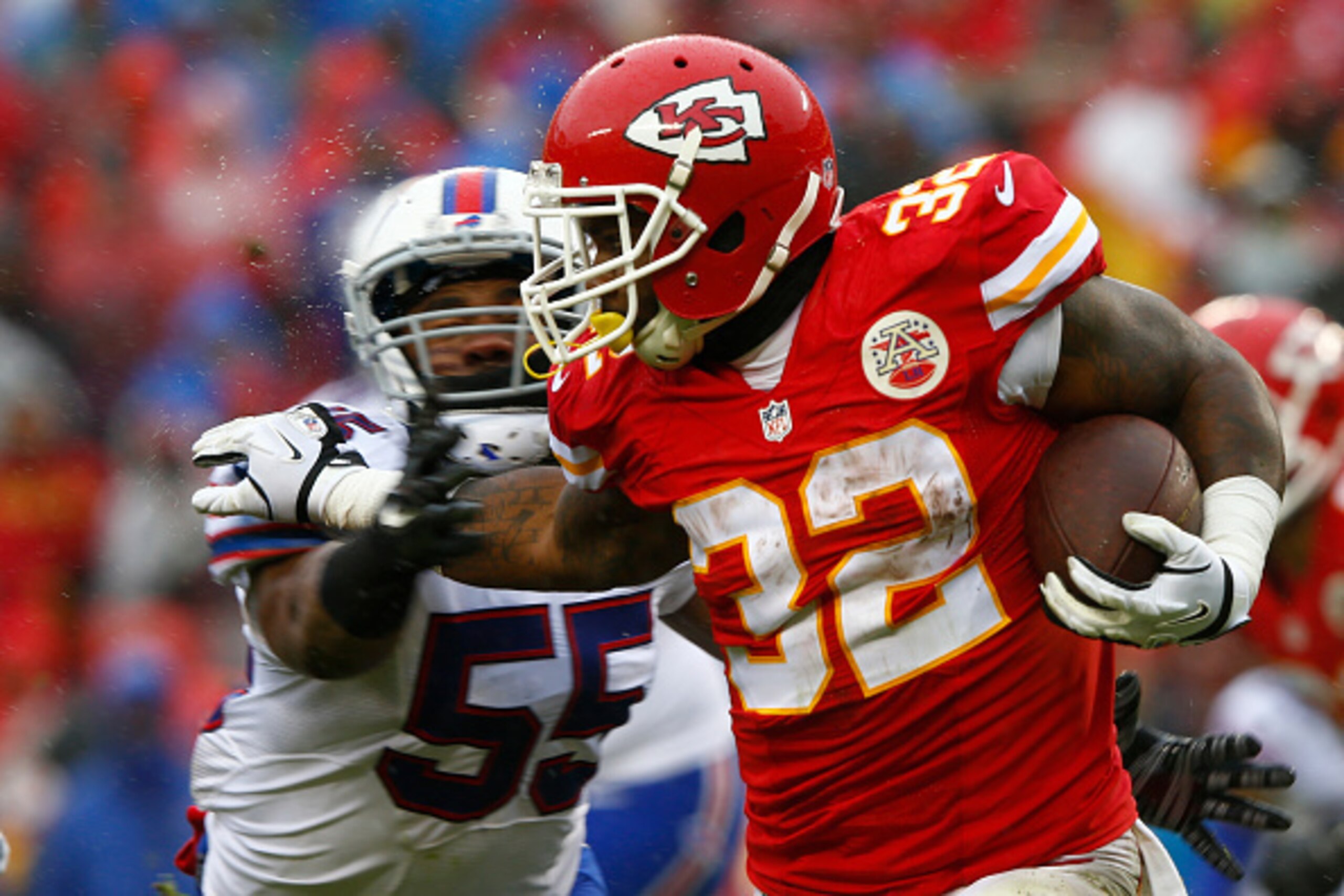 KANSAS CITY, MO - NOVEMBER 29: Spencer Ware #32 of the Kansas City Chiefs tries to avoid the tackle of Jerry Hughes #55 of the Buffalo Bills at Arrowhead Stadium during the first quarter of the game on November 29, 2015 in Kansas City, Missouri. (Photo by KANSAS CITY, MO - NOVEMBER 29: Spencer Ware #32 of the Kansas City Chiefs tries to avoid the tackle of Jerry Hughes #55 of the Buffalo Bills at Arrowhead Stadium during the first quarter of the game on November 29, 2015 in Kansas City, Missouri. (Photo by