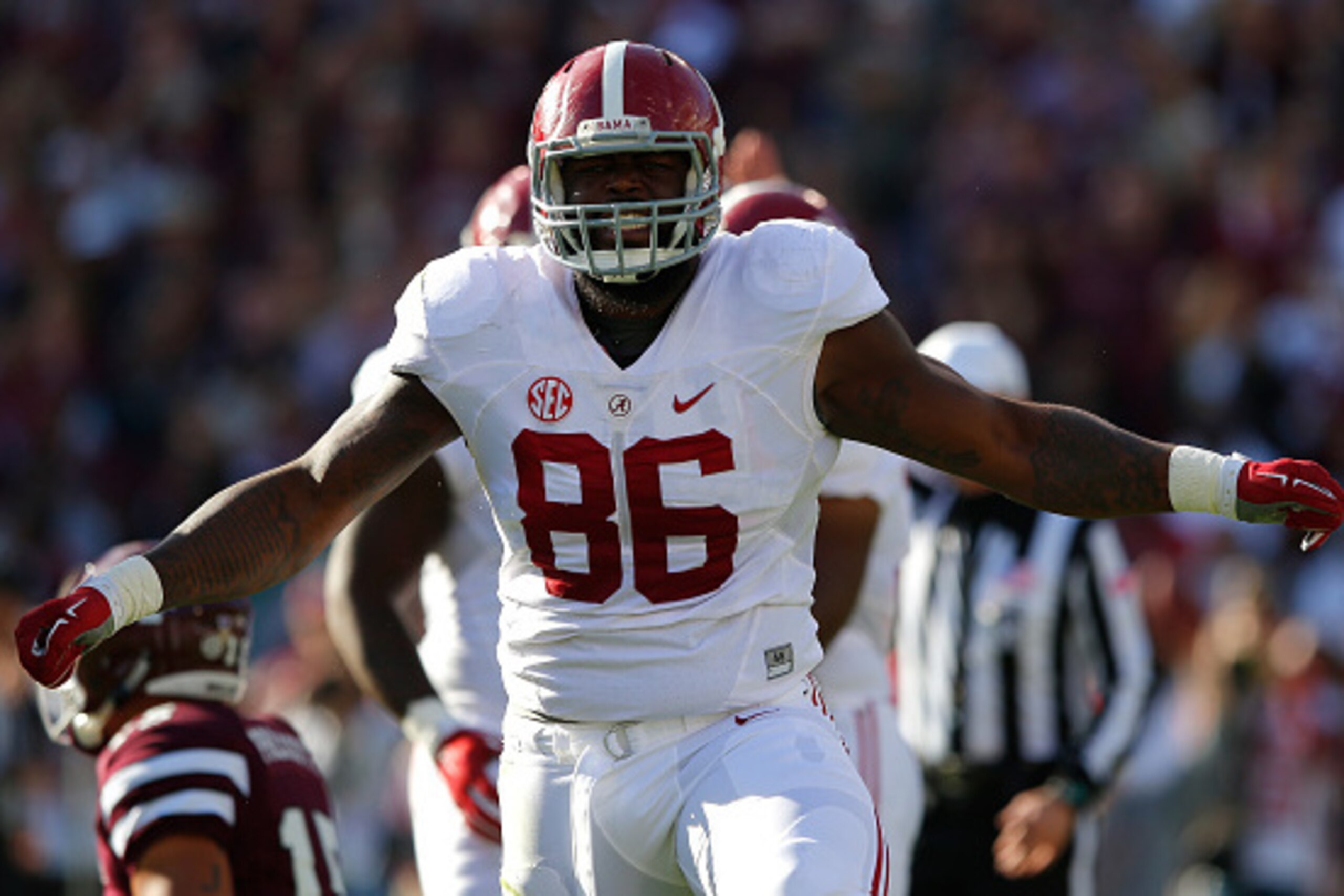 STARKVILLE, MS - NOVEMBER 14:  A'Shawn Robinson #86 of the Alabama Crimson Tide reacts after sacking Dak Prescott #15 of the Mississippi State Bulldogs on the first play of the game at Davis Wade Stadium on November 14, 2015 in Starkville, Mississippi.  (