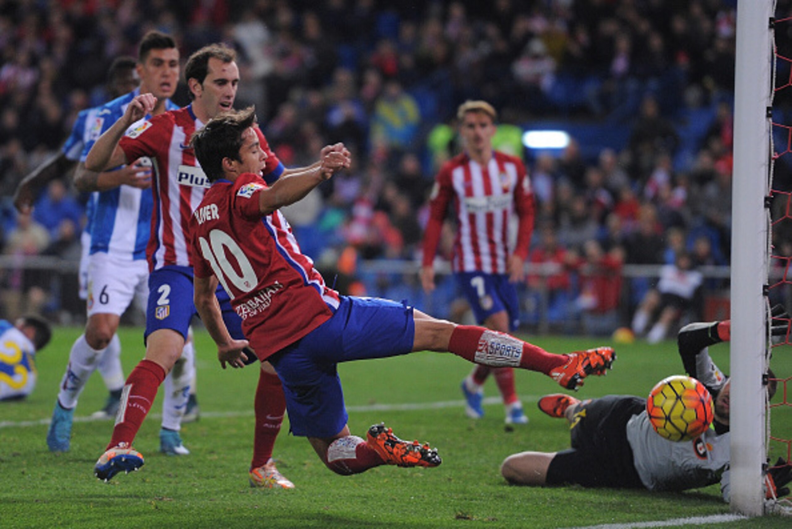 MADRID, SPAIN - NOVEMBER 28:  Oliver Torres of Club Atletico de Madrid tries to shoot past Pau Lopez of Real CD Espanyol during the La Liga match between Club Atletico de Madrid and Real CD Espanyol at Vicente Calderon Stadium on November 28, 2015 in Madr