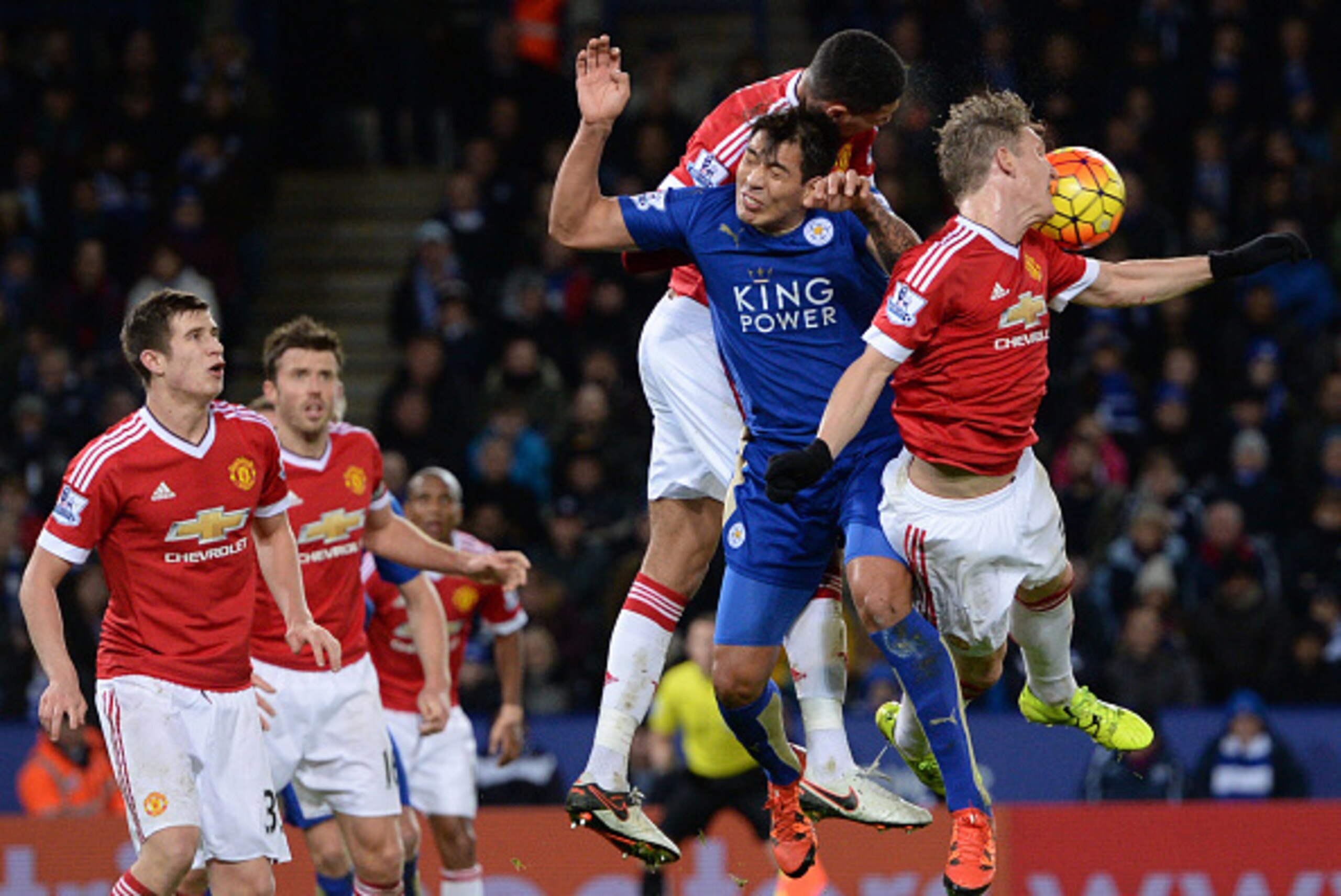 Manchester United's English defender Chris Smalling and Manchester United's German midfielder Bastian Schweinsteiger (R) jump for a header with Leicester City's Argentinian striker Leonardo Ulloa (2R) during the English Premier League football match betwe