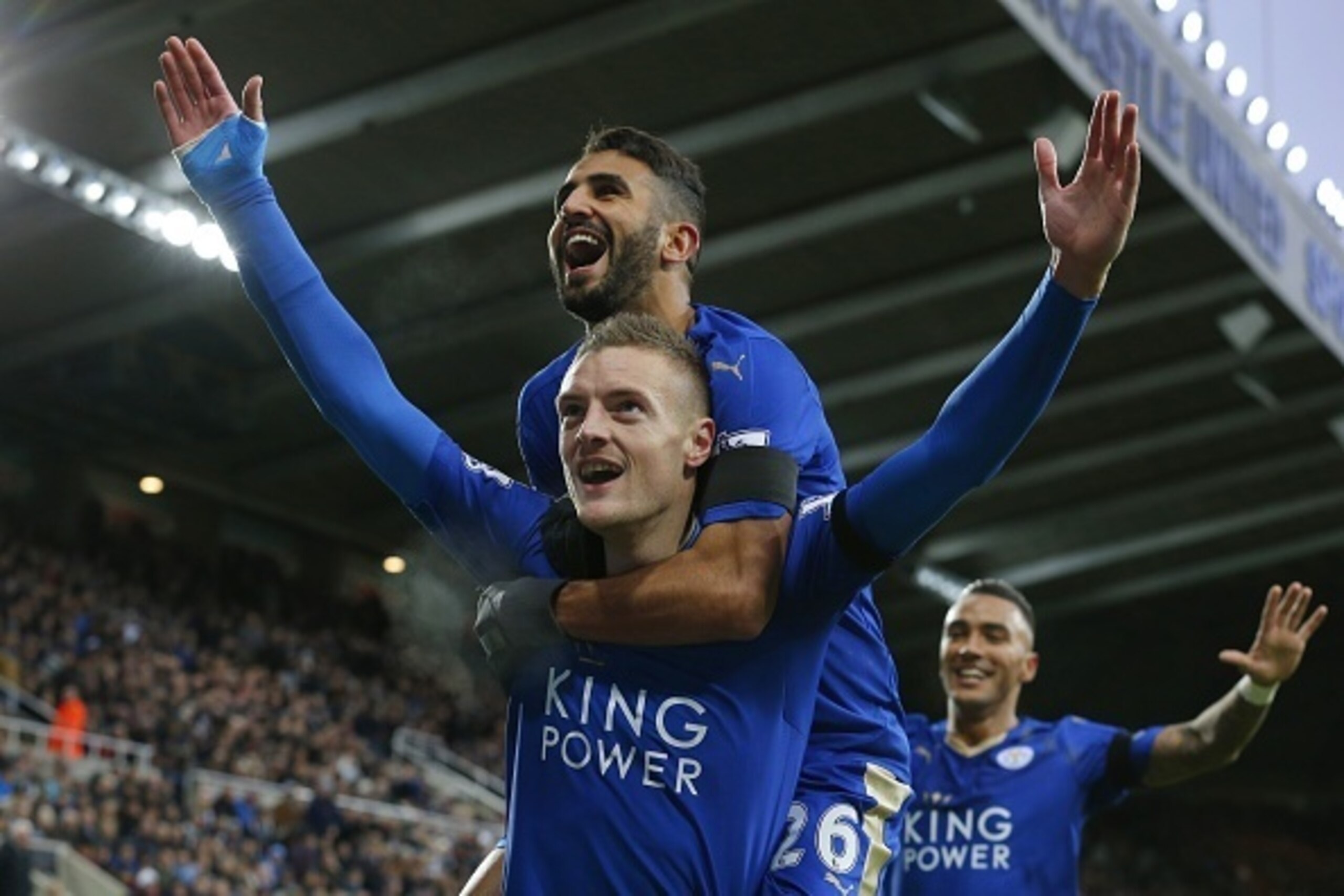 Leicester City's English striker Jamie Vardy (Below L) celebrates after scoring his team's first goal during the English Premier League football match between Newcastle United and Leicester City at St James' Park in Newcastle-upon-Tyne, north east England