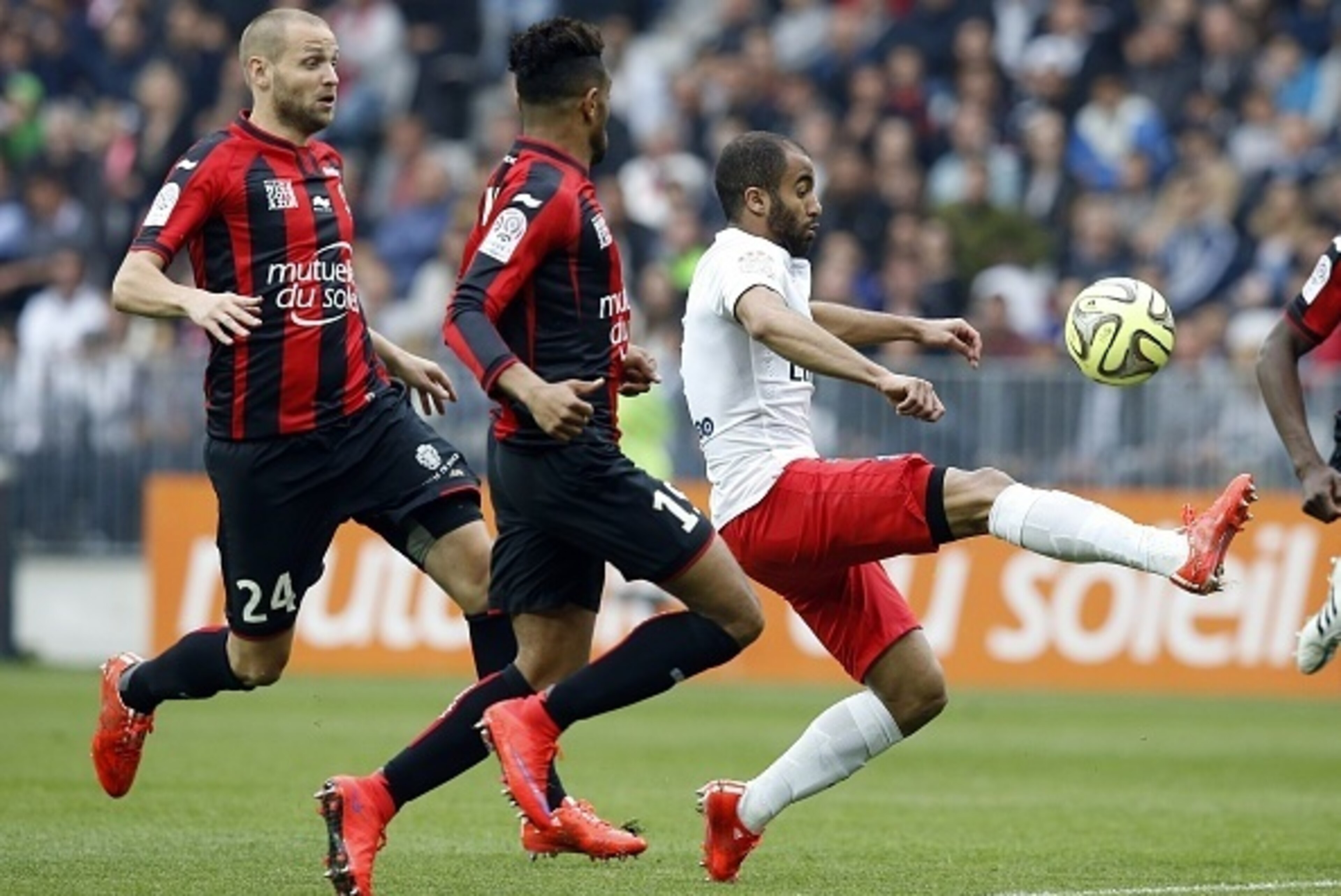 and Paris Saint-Germain's Brazilian midfielder Lucas Moura (R) vies with Nice's French midfielder Mathieu Bodmer (L) and  Nice's French defender Jordan Amavi (C) during the French L1 football match Nice (OGC Nice) vs Paris Saint Germain (PSG) on April 18,
