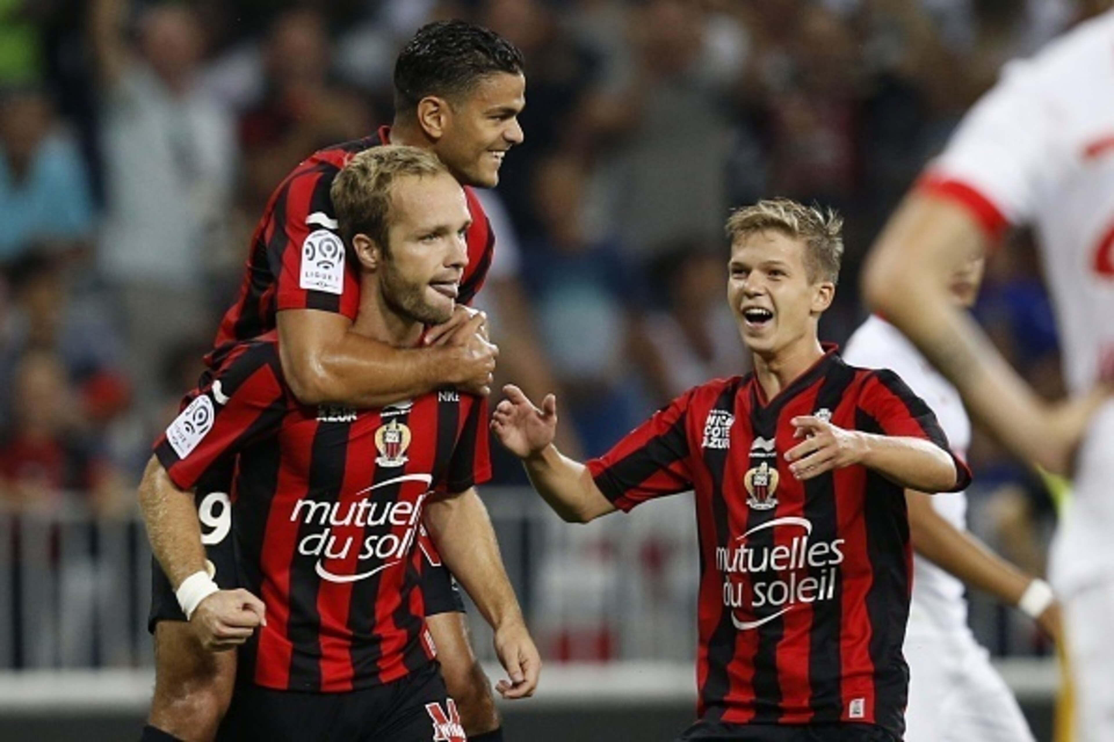 Nice's French forward Valere Germain (L) celebrates with Nice's French forward Hatem Ben Arfa (back L) and Nice's French midfielder Vincent Koziello (R) after scoring a goal during the French L1 football match between Nice and Monaco at the Allianz Rivier