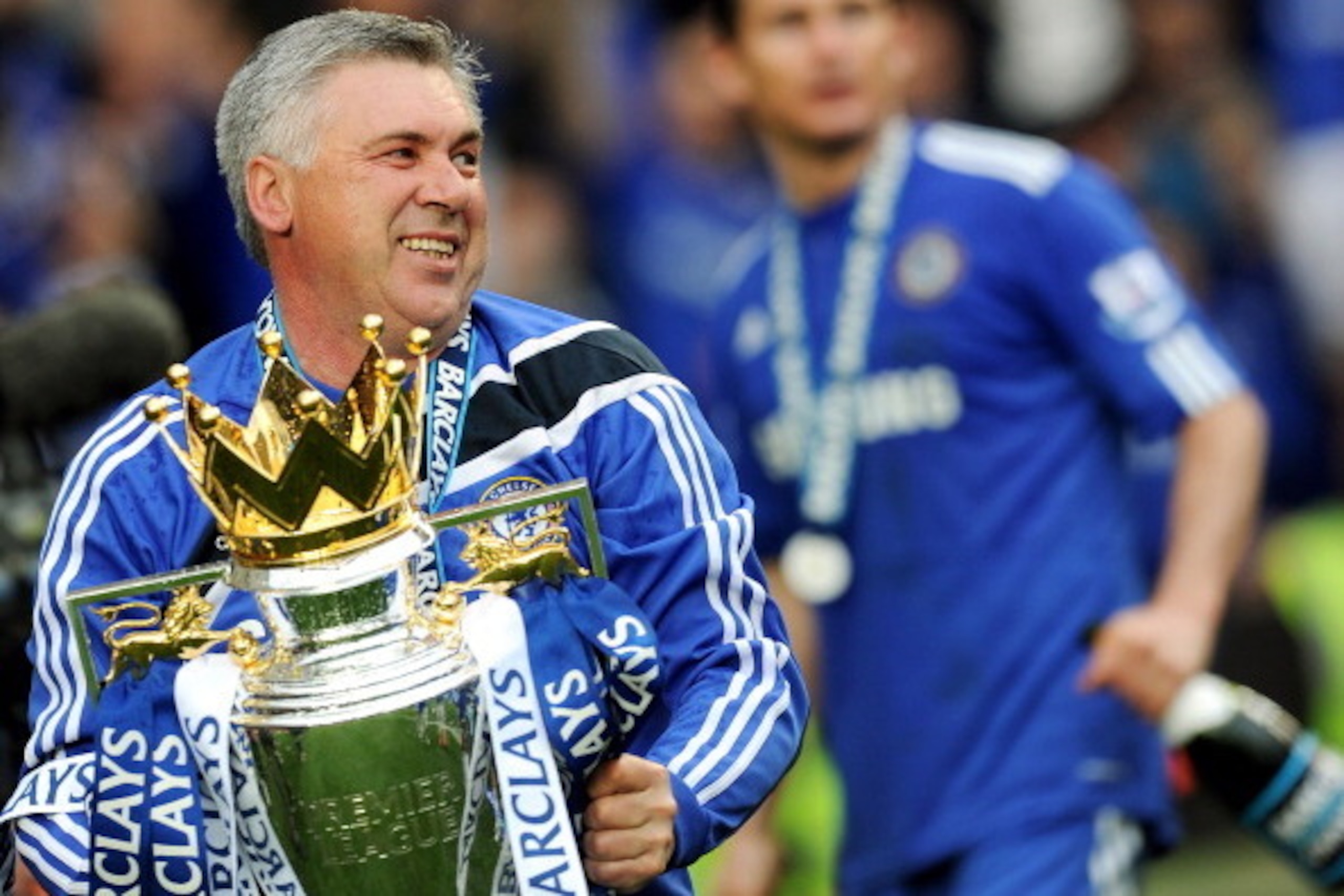 Chelsea's Italian manager Carlo Ancelotti celebrates with the Barclays Premier League trophy after Chelsea win the title with a 8-0 victory over Wigan Athletic in the English Premier League football match at Stamford Bridge, West London, England, on May 9