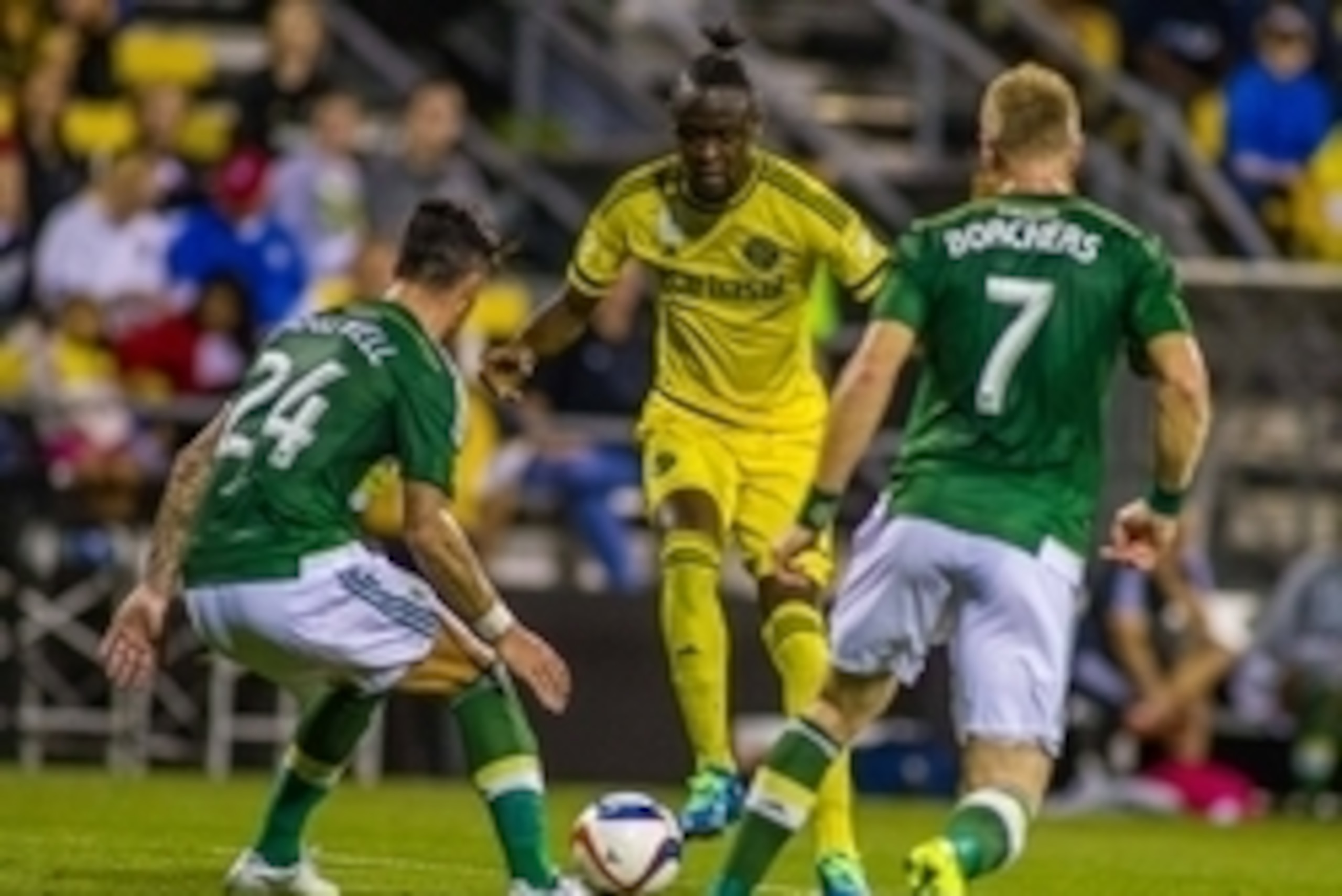 Sep 26, 2015; Columbus, OH, USA;  Columbus Crew SC forward Kei Kamara (23) dribbles the ball between Portland Timbers defender Liam Ridgewell (24) and  defender Nat Borchers (7) in the first half of the game at MAPFRE Stadium. The Portland Timbers beat th
