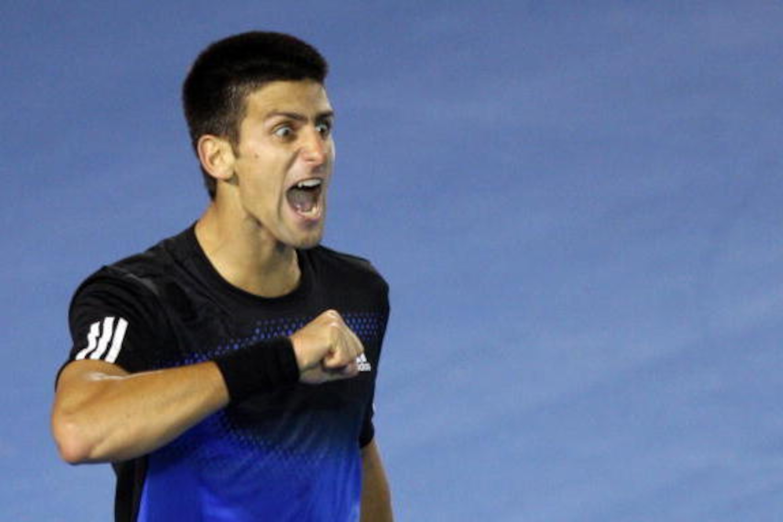 Serbian tennis player Novak Djokovic beats his chest as he celebrates winning a point during his mens singles final against French opponent Jo-Wilfried Tsonga at the Australian Open tennis tournament in Melbourne, 27 January 2008. Djokovic leads by two se
