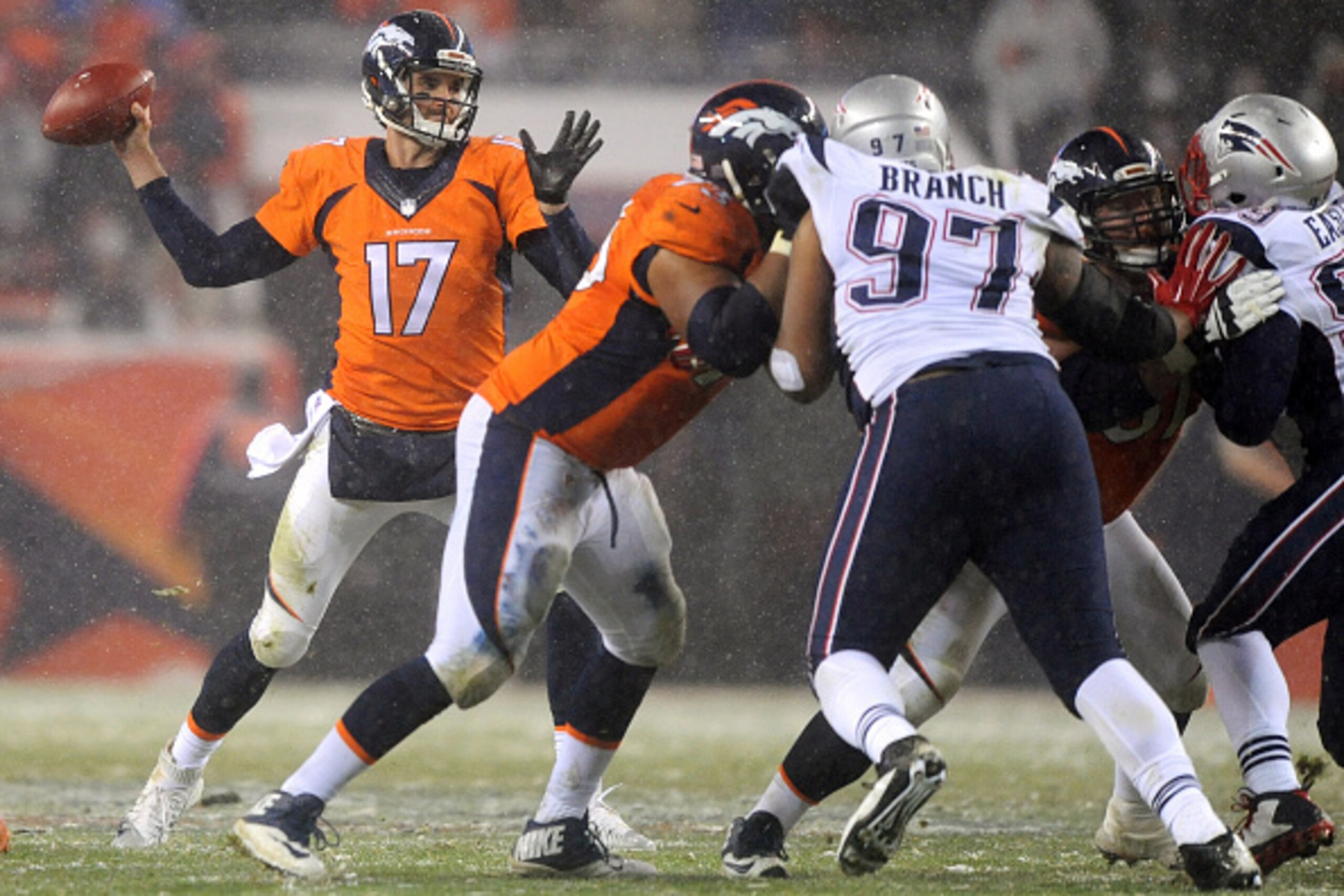 DENVER, CO - NOVEMBER 29: Quarterback Brock Osweiler #17 of the Denver Broncos throws the ball while defensive tackle Alan Branch #97 of the New England Patriots defends in the fourth quarter at Sports Authority Field at Mile High on November 29, 2015 in DENVER, CO - NOVEMBER 29: Quarterback Brock Osweiler #17 of the Denver Broncos throws the ball while defensive tackle Alan Branch #97 of the New England Patriots defends in the fourth quarter at Sports Authority Field at Mile High on November 29, 2015 in