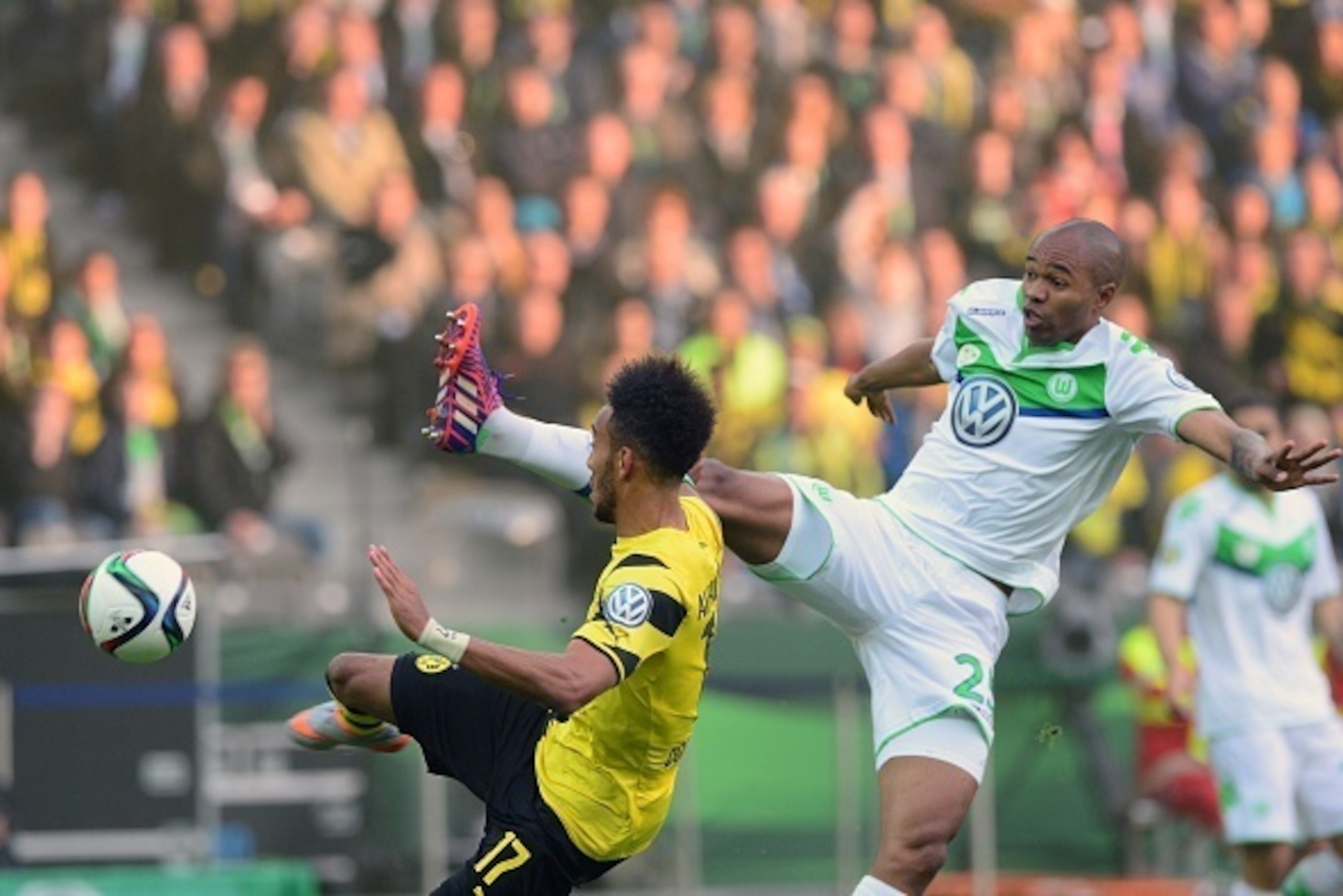 Dortmund's Gabonese striker Pierre-Emerick Aubameyang (L) aims to score the opening goal next to Wolfsburg's Brazilian defender Naldo  during the German Cup DFB Pokal final football match between BVB Borussia Dortmund and VfL Wolfsburg at the Olympic Stad