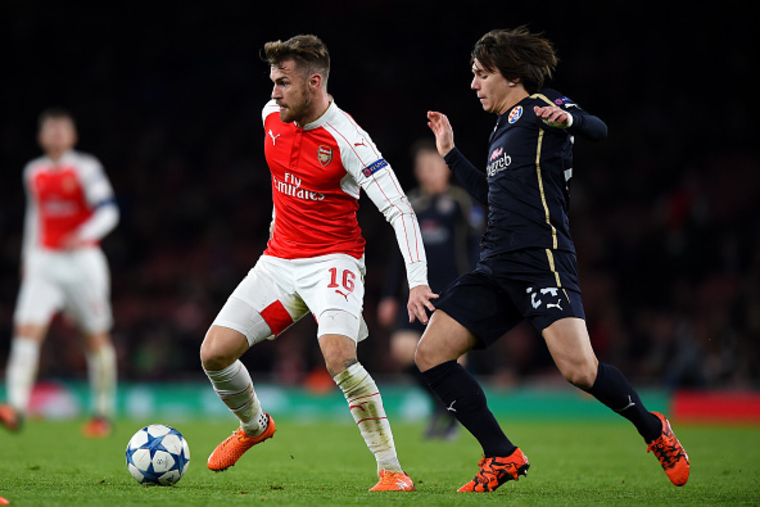 LONDON, ENGLAND - NOVEMBER 24:  Aaron Ramsey of Arsenal holds off Ante Coric of Dinamo Zagreb during the UEFA Champions League match between Arsenal FC and GNK Dinamo Zagreb at Emirates Stadium on November 24, 2015 in London, United Kingdom.  (Photo by Sh