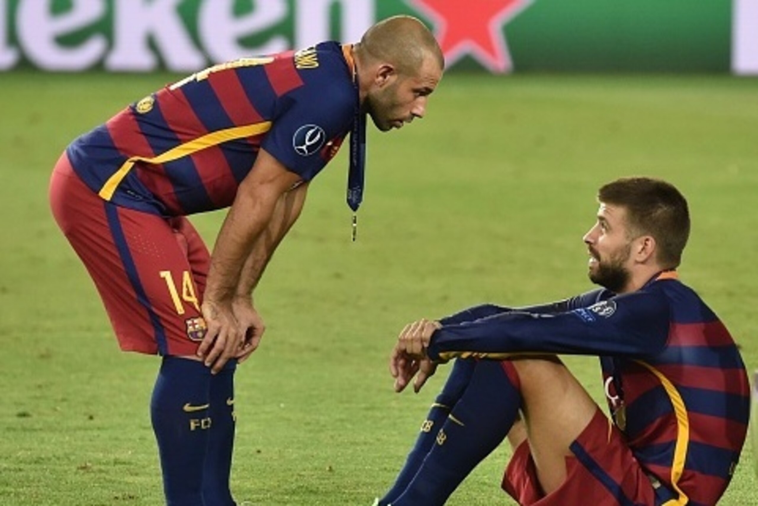 Barcelona's Spanish defender Gerard Pique and Barcelona's Argentinian defender Javier Mascherano (L) react after winning the UEFA Super Cup final football match between FC Barcelona and Sevilla FC on August 11, 2015 at the Boris Paichadze Dinamo Arena in 
