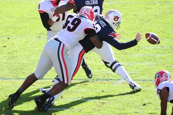 AUBURN, AL - NOVEMBER 14: Sean White #13 of the Auburn Tigers fumbles after being hit by Jordan Jenkins #59 of the Georgia Bulldogs on November 14, 2015 at Jordan Hare Stadium in Auburn, Alabama. Photo by Scott Cunningham/Getty Images)