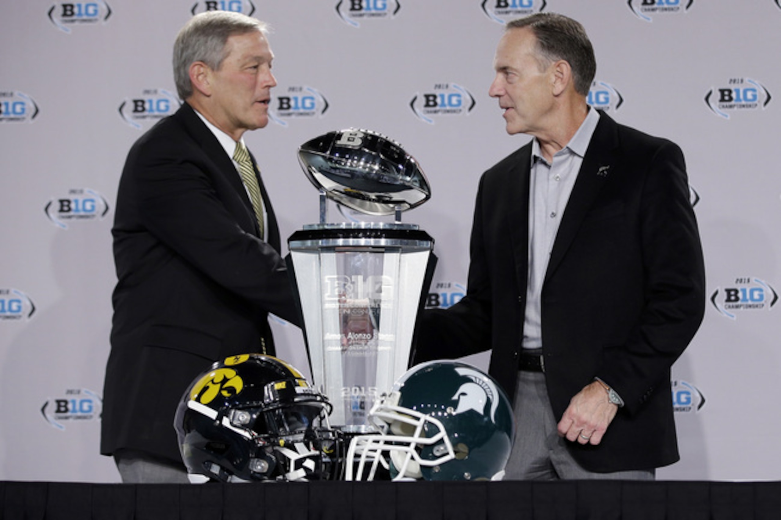 Iowa head coach Kirk Ferentz (left) and Michigan State head coach Mark Dantonio shake hands before the Big Ten title game.